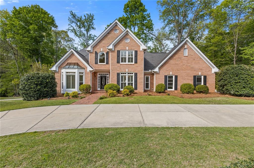 Location! Location! Location! Stunning, well maintained 5 bedroom, 4 and a half bath home nestled on a one of a kind, over an acre lot. Highly sought after neighborhood just walking distance from the wonderful shops and restaurants in downtown Alpharetta. This one of a kind, all brick traditional home was first owned by the builder of Providence Place. It has a new circular driveway plus an additional driveway leading to the 3rd car garage. The main level includes a formal living room and dining room, a family room with vaulted ceilings and an abundance of windows overlooking the private, wooded backyard. The wonderful kitchen has a center island, huge vaulted breakfast room with a gas fireplace. Upstairs, you'll find 3 generously sized secondary bedrooms and 2 full bathrooms all with lots of closet space plus a walk in attic with tons of storage. Downstairs the partially finished terrace level includes and additional garage with a dog bath, a bedroom or den, full bathroom, multiple unfinished rooms, storage space and workshop areas. The huge lot has plenty of space to play, is partially fenced and has a charming gazebo. With ample space for everyone and top-rated schools nearby, this home and neighborhood offer the perfect blend of comfort and convenience. Top rated schools include Summit Hill Elementary, Northwestern Middle and Milton High. Don't miss the opportunity to make this wonderful home yours—schedule your showing today!