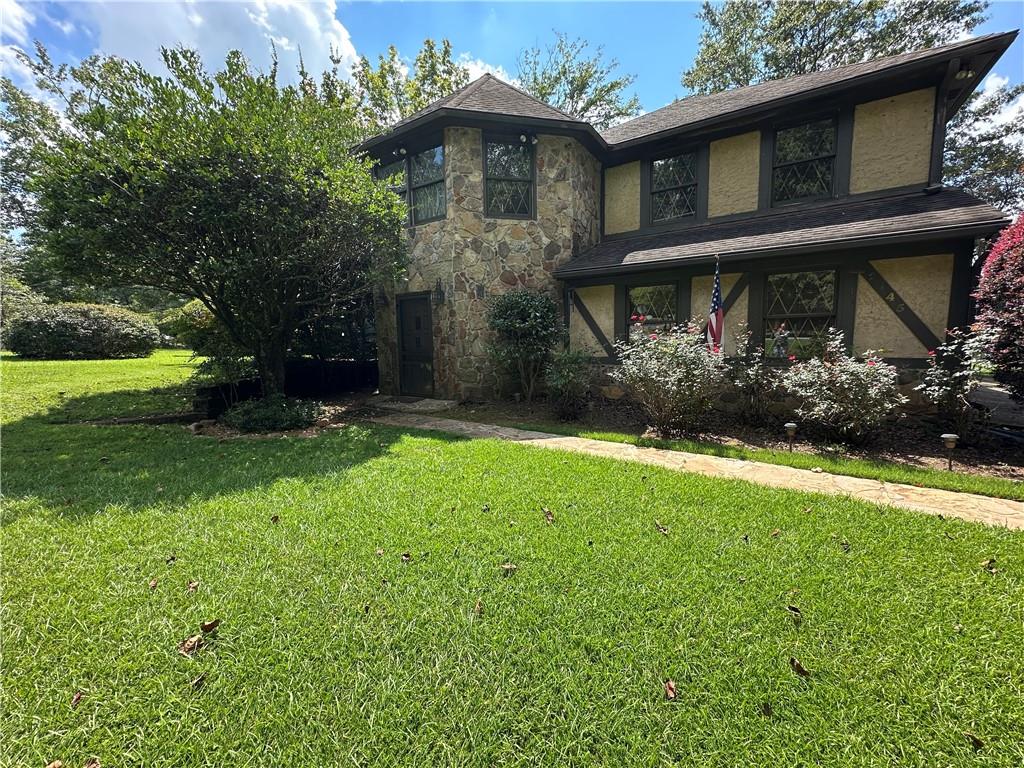 **Custom Built One Owner Home on an Amazing Waterfront Lot in Great Established Neighborhood**Just waiting on a new owner to come in and update this wonderful home. This home has so many unique and well thought of features - Main Level features Beautiful Foyer Entrance with Gorgeous Stone Floors that continue into Family/Sun room with a wall of windows looking over lake as well as Laundry Room that also has a full bath and separate entrance - Built in Bar off of Foyer -Two car garage - Second Level Features Huge Family Room with Fireplace and Triple Windows for tons of natural light - Off of family room is a formal dining room that also opens up to kitchen- Large kitchen with tons or cabinets and counter space and an eat in area with a stone fireplace - French doors opening from kitchen onto huge deck overlooking the lake for all of your entertaining or just sitting outside watching the most beautiful sunsets - Upstairs you will find two large secondary bedrooms with tons of closet space - One of the bedrooms has a sitting area as well as extra closet - Tile hall bath - Master bedroom with awesome Master bath that includes Two closets as well as two vanities, nice shower and tons of space for storage - Close to schools, shopping , restaurants and interstate - Just needs a buyer to come in and make it their own with their updates - Seller is in process of Estate Sale so there is still alot of furnishings and things in property