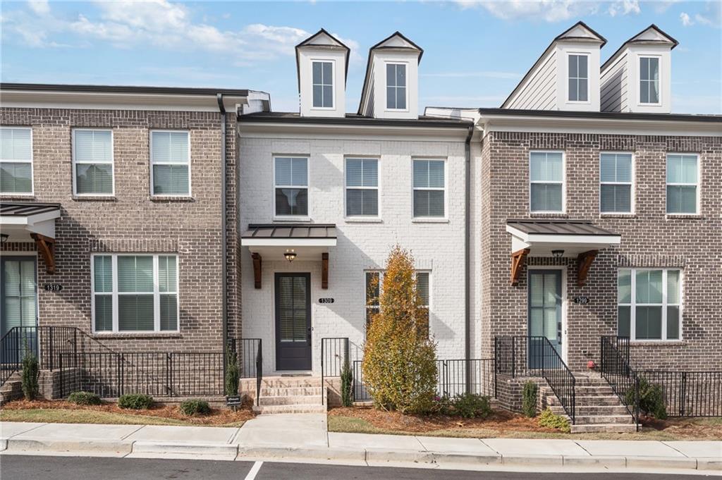 Immaculate executive townhome in the heart of Suwanee! Tucked inside a quiet gated community and just minutes from Suwanee’s renowned greenway trails, this nearly new residence offers the perfect blend of luxury and convenience. Built less than 3 years ago and lightly lived in, the home features a bright, open layout ideal for entertaining. A chef’s kitchen with a large center island. Each bedroom includes its own private bath, while the finished terrace level provides a versatile space for an additional bedroom, home office, or media room, complete with a full bath. Enjoy an oversized private deck, a two-car garage, and timeless brick construction. Community amenities include a sparkling pool and playground. This Suwanee gem offers exceptional square footage, quality, and style at a fantastic value. Move-in ready and waiting for its next owner!