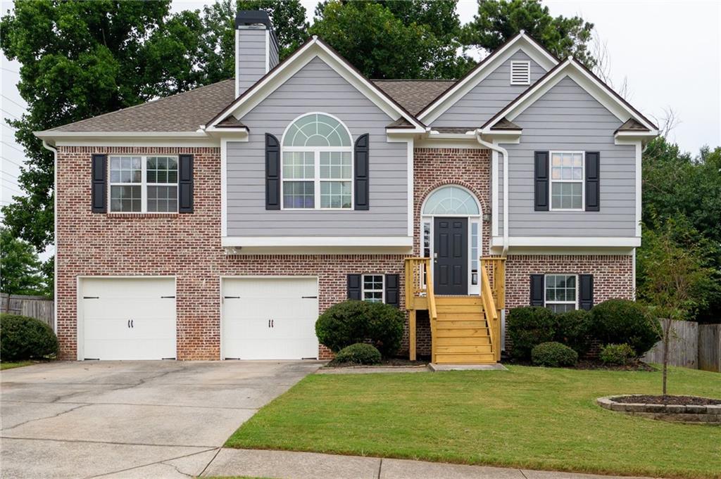 Welcome to this charming 4 bedroom, 3 bathroom split-level home in the heart of Acworth! Step into a bright, vaulted family room centered around a cozy fireplace, flowing seamlessly into the updated kitchen with white cabinets, stainless steel appliances, and a dedicated dining area that overlooks the rear deck and fenced backyard. The oversized primary suite offers tray ceilings and an en-suite bath complete with a double vanity, soaking tub, separate shower and walk-in closet. Two spacious secondary bedrooms share a full bath with a tub/shower combo. Downstairs, you'll find a fourth bedroom, full bath, convenient laundry room, and a second living space with walkout access to the patio and backyard, perfect for entertaining or relaxing! The 2-car garage offers additional storage, and recent updates include new flooring, fresh interior and exterior paint, light fixtures, landscaping and more! This home has been well cared for and is conveniently located near I-75 and the Hickory Grove Express Lane, making commuting a breeze. Enjoy being less than 2 miles from vibrant Downtown Acworth, known as "The Lake City," with its local restaurants, shops, outdoor recreational activities, active festival and events calendar, Lake Acworth, and Lake Allatoona. You're also a short drive to Historic Downtown Kennesaw, full of charm and ongoing development. This one checks all the boxes - space, updates, and a location you'll love!