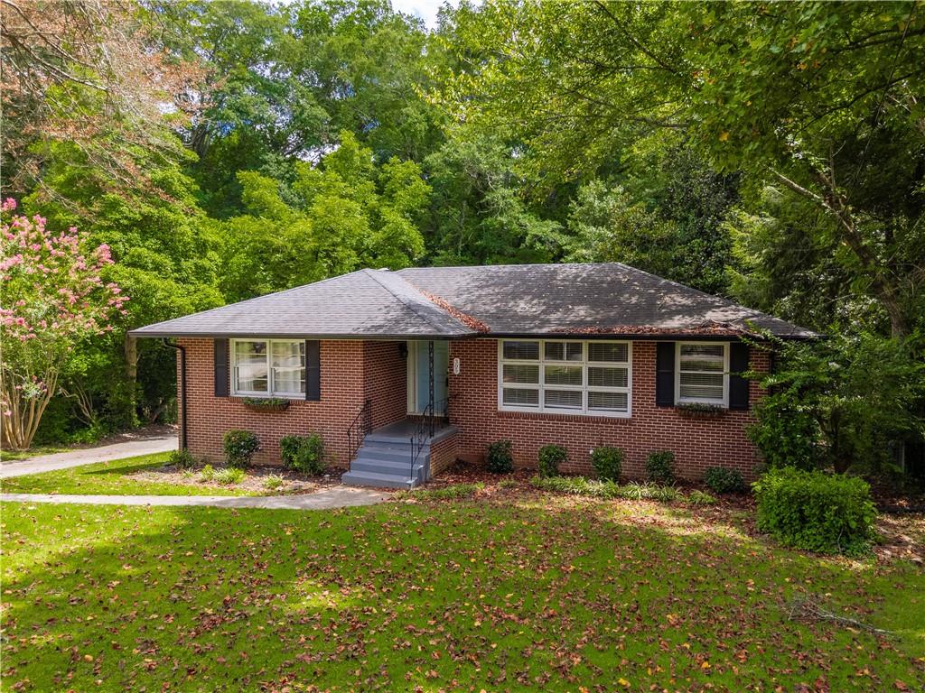 Welcome to 305 Brookwood Dr — an updated mid-century ranch just minutes from the vibrant shops, dining, and events of Marietta Square. This charming home combines classic character with modern updates, offering comfortable living inside and out.
The main level features a bright, open layout with stylish finishes and warm hardwoods throughout. Step out back to enjoy a view of your entire back yard from a large deck with stair access to below. Downstairs, you'll find a fully finished basement complete with its own full bathroom—perfect for a roommate, in-law suite, or flexible bonus space.
Outside, enjoy the peaceful view of a running creek that borders the property. A portion of the yard is fully fenced, making it ideal for pets to roam safely. Whether you're relaxing on the back patio or exploring the nearby square, this home offers the perfect blend of privacy, convenience, and charm.
Don't miss your chance to own this move-in ready gem in one of Marietta's most desirable locations!