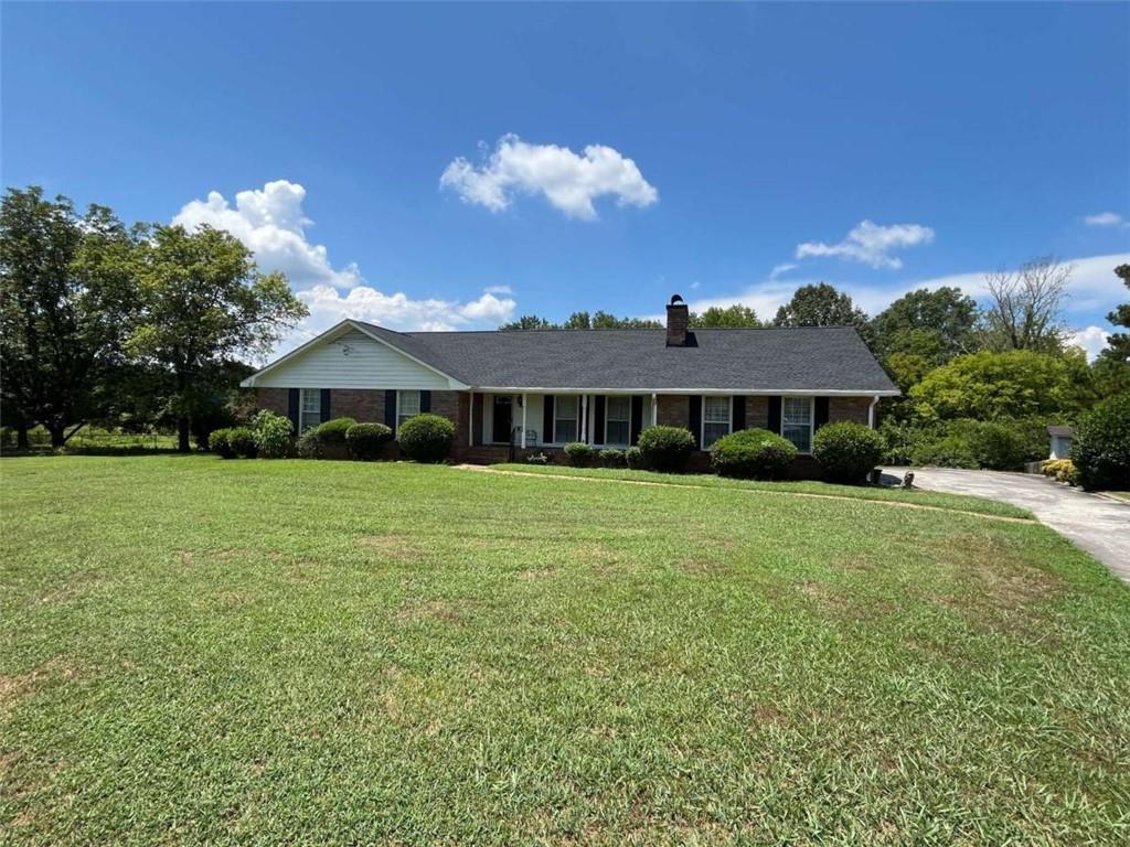 Hard to find 4 sided brick home in Maplewood Square subdivision. Large .6 acre lot with fenced in back yard that overlooks a pasture that runs along the Etowah river. This location provides privacy, quiet and beautiful sunsets in the evening that is enjoyed from the screened in porch. The living area includes a large living room, separate dining room and den. In the carport area is a 14'x14' storage room with power that has been used as an office in the past. Beautiful hardwood floors throughout, one year old roof.