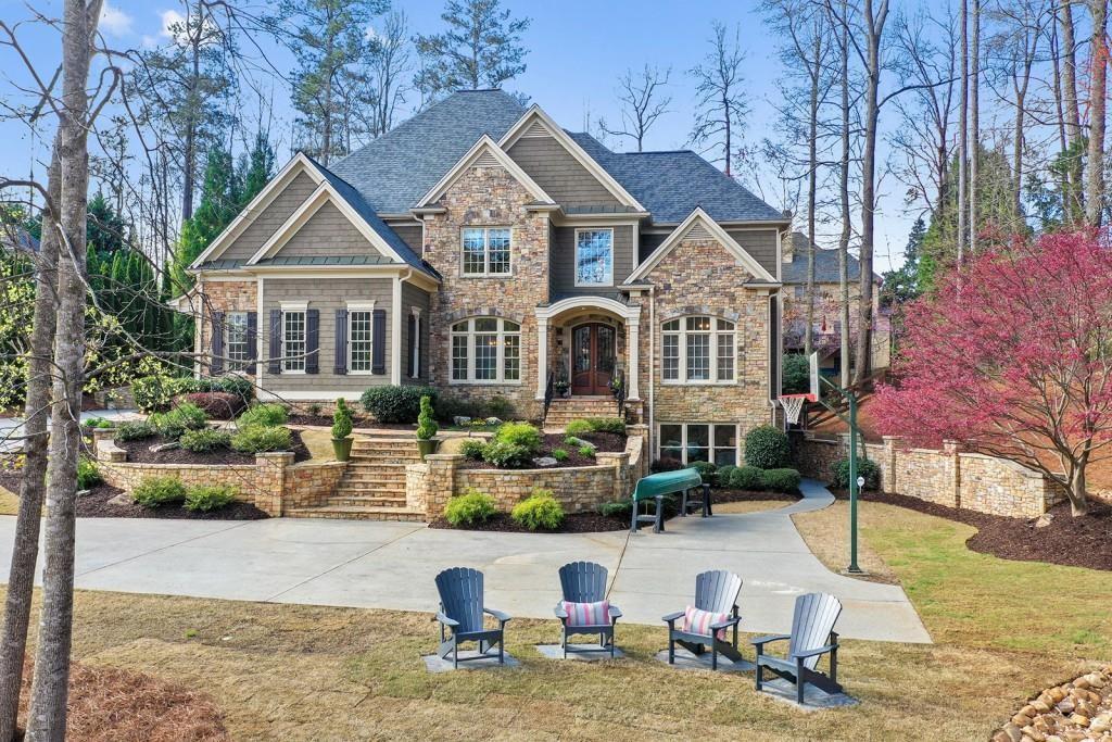 Experience luxury lakefront living in this stunning custom-built estate home , privately nestled at the end of a secluded drive in one of the area’s exclusive community . Situated on over an acre of professionally landscaped grounds, this meticulously maintained home offers elegance, privacy, and breathtaking natural beauty. The open-concept floor plan is filled with natural light and upscale finishes, featuring a gourmet chef’s kitchen with premium appliances, custom cabinetry, kitchen that flows into a large keeping room and bright breakfast area. The main-level primary suite is a serene retreat with its own fireplace, access to a covered porch overlooking the lake, a spa-like bath with a soaking tub and walk-in shower, and a large custom closet. With six bedrooms and six bathrooms, this home provides abundant space for luxurious everyday living. The fully finished daylight basement has been freshly painted and includes a private home theater and expansive living area, all with stunning views of the private lake. Outdoor living is equally exceptional with an extended stone patio, private backyard, mature trees, and tranquil water views—offering the perfect setting for both relaxation and entertaining. This home blends timeless craftsmanship with modern updates and is in impeccable condition, ready for immediate move-in. Located in a private community close to top schools, dining, and commuter routes, elegance and comfort in a peaceful, resort-like setting. Don’t miss your chance to live in this one-of-a-kind lakefront retreat. Children could attended Roswell schools or Cobb Schools.