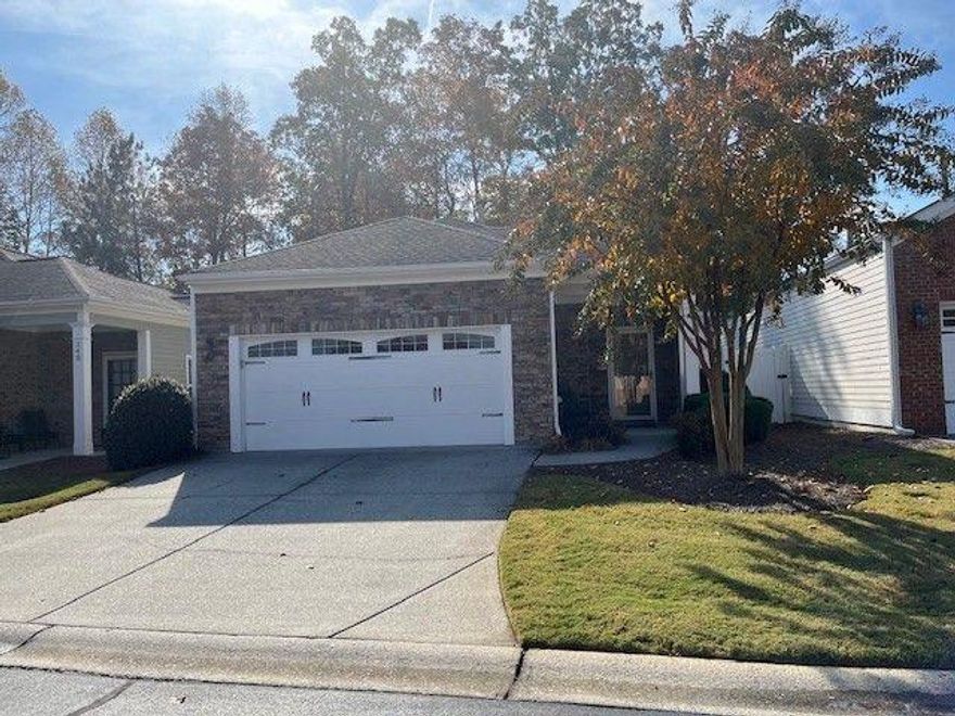 Stunning move-in ready ranch home in 55+ Active Adult popular community with many on and off-site activities.  Two spacious bedrooms, two tiled baths with hard surface counter tops and awesome sunroom with tile flooring.  Open concept living with hardwood floors in living area and carpet flooring in bedrooms.  Kitchen has hard surface countertop, pantry, breakfast bar and all appliances remain.  Living area has cozy gas fireplace that comes on with a flip of the switch.  Primary suite is spacious with sliding glass doors leading to the patio area.  Spa bath has his and her vanities and walk in shower.  Laundry room has shelving for laundry supplies and washer and dryer remain.  Water heater and roof are 3 years old.  HOA replaces the roof when it is time and paints the exterior of the homes when it is time.  Home is located on a beautiful home site and backs up to the forest.  Fence enclosed patio offers space for the avid gardener and patio dining.  Community has club house for gathering activities and was recently completely renovated.  Club house has fitness room, library, kitchen and large gathering room.  Swimming pool is enjoyed during warm summer months.