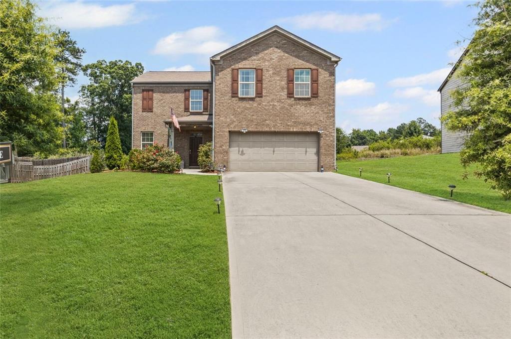 This spacious 4 bedroom, 2.5 bath home sits on almost half an acre, offering a rare combination of space and privacy in a quiet Douglasville community. The main level features a comfortable, open layout with a large living room, dining area, and kitchen with center island, perfect for everyday living and entertaining. Upstairs, all four bedrooms are thoughtfully arranged, including a generous primary suite with a walk-in closet and dual vanity. Step outside to enjoy the flat, private backyard, ideal for play, pets, gardening, or simply relaxing outdoors. Conveniently located near I-20, schools, and local amenities, this home offers the best of both space and accessibility. A must-see for buyers looking for comfort, value, and room to grow.