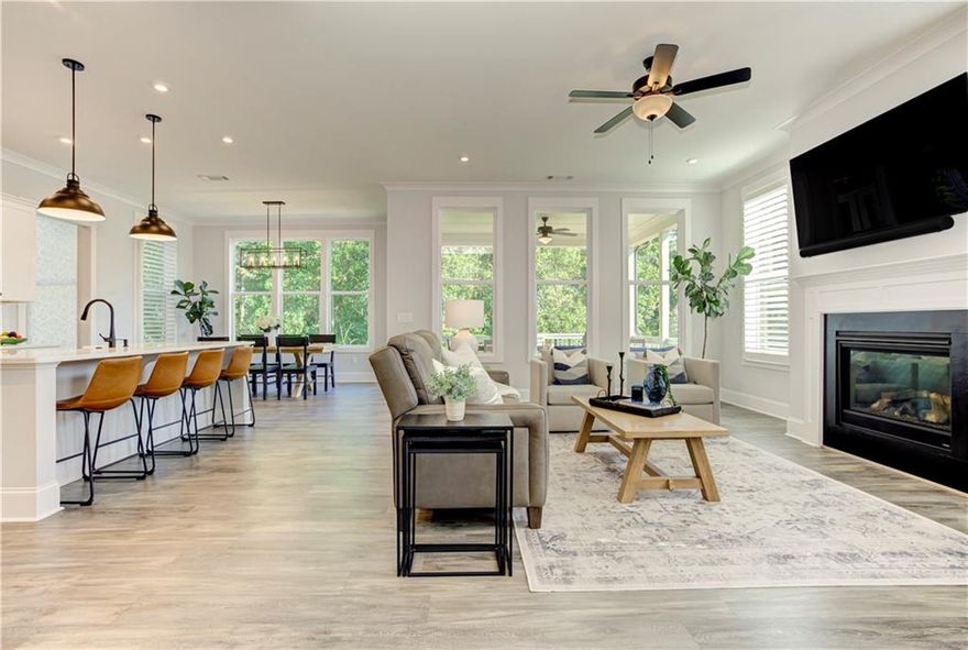 Welcome to this immaculate move-in ready home located within a short walk to Downtown Woodstock!  This gently lived in home is better than new and shows like a model with the appeal of a 'lock and leave' lifestyle with upgrades galore! Invite your friends and neighbors to this spacious light-filled entertaining home with an open concept kitchen, fireside family & dining room with 10 foot ceilings and large windows bringing in the outdoors overlooking private views of the trees. The kitchen is appointed with gleaming appliances, vent hood over a 5 burner gas cooktop, gorgeous tile back splash, and beautiful quartz countertops. The large island features a porcelain farm house sink and a trash/recycling pull out. There is plenty of storage in the large custom walk in pantry, soft close cabinets with pull outs, and every detail has been considered. As you enter from the garage, kick off your shoes, hang your keys & jacket then unwind after being met with a mud room complete with hooks, cubbies, and a bench; and, yet another large custom closet. Savor the views of the wooded back yard throughout your day on the deck and covered porch with a morning coffee and bird watching, a peaceful afternoon nap, or the tranquility of dusk with frequent deer sightings. The primary suite is complete with an expansive custom closet attached to the bath with dual sinks, water closet, and gorgeous tiled shower. The laundry room is conveniently located next door with considerable storage in custom cabinets, waterfall countertop for folding laundry over washer/dryer, and a double hamper. The loft area has endless possibilities and another space to customize to your needs whether it be another TV or study area, library, or a den.  Retreat to the terrace level to enjoy movies and football games complete with a wet bar, wine fridge, and walk out to the private patio area. This level boasts a large bedroom with two custom closets and full bathroom for guests.  Plenty of additional space for storage in large unfinished mechanical room as well as two additional spacious closets. The neighborhood amenities include a park with a pavilion, fire pit, grassy area for lawn games, pool, cabana, scattered benches throughout neighborhood, and two dog parks. Imagine a walk or short golf cart ride from Inwood along quaint Rope Mill Road into the bustling, yet charming, town of Woodstock. Enjoy parks, walking trails, concerts on the green or amphitheater, art exhibitions at the Reeves House, the farmer's market, the local theater, and engage with neighbors in town as you shop and dine at local restaurants. Immerse yourself and be part of this growing community. Inwood is tucked away yet close to the outlet mall, Costco, and access to interstate 575.