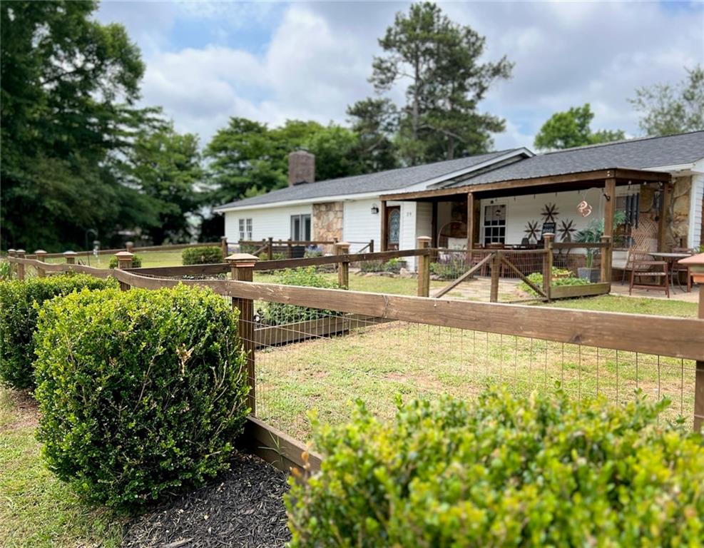 Stunning renovation! This 1-story ranch home sits on just little over an acre of land. This captivating 3-bedroom ranch home has a timeless charm and an abundance of modern farmhouse amenities, this residence offers the perfect balance of comfort, convenience, and style. Prepare to be impressed as you step into this tranquil oasis designed for both relaxation and entertaining.
In the living room you are greeted by abundance of natural light. The open floor plan seamlessly connects the living room to the kitchen area, creating a spacious ambiance ideal for hosting gatherings with family and friends. Imagine cozy evenings by the wood burning fireplace, creating cherished memories that will last a lifetime. The well-appointed kitchen is a chef's delight, featuring sleek concrete countertops, stainless steel appliances, ample storage, and a massive kitchen island. Whether you're preparing a quick breakfast or whipping up a gourmet feast, this kitchen provides the perfect setting to unleash your culinary skills.
Retreat to the expansive primary bedroom, complete with a private ensuite bathroom and a walk-in closet. The two additional bedrooms offer versatility and can be customized to fit your specific needs. They are perfect for creating a home office, a serene guest room, or a playroom for the little ones.
Step outside and discover a true outdoor paradise. The backyard is a haven for relaxation, with a spacious patio area that's perfect for alfresco dining, summer barbecues, or simply unwinding after a long day. Enjoy the beauty of lush greenery and create your own private garden oasis or play area for children and pets.
Conveniently located, this home offers easy access to a plethora of amenities. Nearby shopping centers, restaurants, and entertainment options ensure that you'll never have to venture far to find what you need. Excellent schools and parks are just a stone's throw away.
Additional features of this remarkable ranch home include a massive 20x40 workshop, an RV 50 AMP hookup, a laundry room, and energy-efficient upgrades. The timeless exterior exudes curb appeal and welcomes you with open arms every time you arrive home.