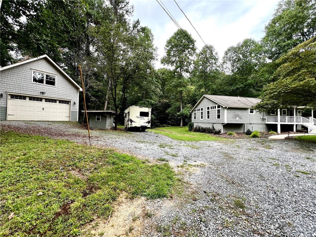 Charming Renovated Ranch Home in Peaceful Ellijay
Nestled on a serene peninsula on 2.66 acres surrounded by a peaceful creek, this beautifully renovated 3-bedroom, 3-bath home offers privacy and soothing water views. Enjoy the water views from both the rocking chair front porch and back porch—perfect for unwinding while listening to the soothing sounds of flowing water with a cup of your favorite morning coffee or nightcap. Turkey Creek does have stocked trout, typically twice a year (March and May)
Inside, the spacious living room features high ceilings, gleaming hardwood floors, and a wood-burning buck stove with custom stonework extending up to the ceiling. The modern kitchen boasts custom-made cabinetry, granite countertops, and stainless steel Frigidaire appliances, blending style and functionality. The bathrooms also showcase custom cabinetry for a cohesive design.
Two master suites each include a full private bathroom, providing comfort and convenience. A detached two-car garage/workshop with a loft offers ample storage or the potential for a cozy office or apartment space.
This home is ideal for a family retreat or a short-term rental opportunity, combining tranquility with easy access to local amenities.
