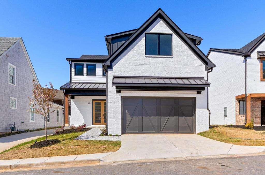 Welcome to Peachtree City's newest upscale mixed-use community, Laurel Brooke, with this 4-bedroom/4.5 bath/bonus room/loft/ vaulted patio all in the McIntosh School District. **Builder is contributing $10,000 towards buyer's closing cost. Gorgeous hardwood floors throughout the entire house. The main level features an oversized open chef's kitchen with custom cabinetry, LG Studio Appliances, a beverage station with a micro-fridge, a mini sink, and a wine rack. The living room has vaulted ceilings with cedar beams and wall-to-wall built-ins leading to the four folding livingroom doors. The primary suite on the MAIN LEVEL with oversized glass walk-in shower will not disappoint. Upstairs are three bedrooms and three baths, a bonus room, and an open loft perfect for the flex space. Quality spray foam insulation in the attic for the highest energy efficiency. Preinstalled for auto and cameras. Garage floor complete with commercial grade epoxy flooring. The subdivision boasts charming pocket parks for residents and Peachtree City's 100+ miles of paved cart paths. Laurel Brooke is Peachtree City's first mixed-use development, including luxury custom homes, a high-end Condo complex, guest cottages, and a commercial business area. It is conveniently located just minutes from shopping, dining, award-winning Peachtree City schools, and Trilith Studios. It is just 30 minutes from Hartsfield-Jackson Atlanta International Airport!