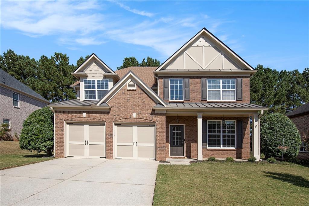 Welcome home to this beautiful three-sided brick residence offering timeless charm and modern comfort! Step inside to a spacious family room featuring a cozy fireplace, perfect for gathering with family and friends. A separate dining room provides an elegant space for hosting dinners and celebrations. The bright and inviting eat-in kitchen boasts solid surface countertops, a center island, pantry, and sleek stainless-steel appliances—ideal for both everyday living and entertaining. The serene primary suite is a true retreat with a large walk-in closet and a luxurious ensuite bathroom complete with dual vanities, a soaking tub, and a separate shower. A versatile bonus room offers the perfect space for a home office, playroom, or media area. Enjoy relaxing mornings on the charming front porch or unwind on the back patio overlooking the yard. With a two-car garage and exceptional curb appeal, this home perfectly blends classic style and comfort for today’s lifestyle.