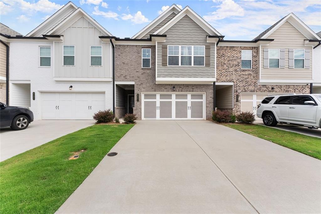 Welcome to 5201 Fox Den Road, a beautifully maintained townhome in the desirable Silver Fox Reserve community of Oakwood. This townhome offers the perfect blend of modern design and everyday comfort. Featuring three spacious bedrooms and two and a half baths, the home includes an oversized primary suite with a luxurious full bath and private retreat. The open floor plan, spanning two levels, provides ample space for both relaxation and entertaining. The exterior showcases timeless curb appeal with a brick and stone façade, while the interior boasts energy-efficient construction and stylish finishes designed for low-maintenance living. An attached two-car garage offers convenience and extra storage. Residents of Silver Fox Reserve enjoy access to community amenities, including a swim center, and benefit from the neighborhood’s proximity to I-985, Lake Lanier, and the shops and dining of Oakwood, Flowery Branch, and Gainesville. Offering both comfort and convenience, this move-in-ready townhome is an ideal choice for buyers seeking a modern lifestyle in a vibrant community.