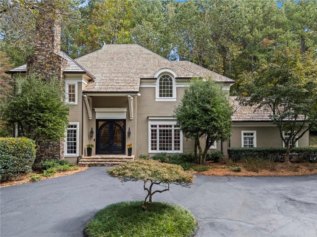 Bill Harrison designed European beauty in Sandy Springs.  Welcome home to your very own resort complete with swimming pool and tennis/pickle ball court.  Gated entry welcomes you home to this hardcoat stucco home on a quiet, peaceful street bordering Buckhead without City of Atlanta taxes.  Convenient to all the private schools and minutes to shopping, restaurants and the Chattahoochee River.  Soaring ceilings throughout. Kitchen and master bath were both completely renovated less than 5 years ago with no detail missed.  Top of the line kitchen appliances, white oak island and gleaming hardwoods throughout majority of home and beautiful Saltillo tile in the terrace level living areas.  Full house generator, dry sauna, gym and fenced backyard. No lack of storage.  This one is not to be missed!