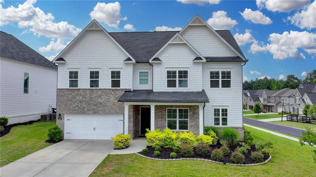 Step into timeless elegance with this stunning home, nestled in the prestigious Holbrook Reserve community built by TOLL BROTHERS—offering resort-style amenities including a sparkling pool and well-maintained tennis courts. Built by the renowned Toll Brothers, this popular Hillside floor plan impresses from the start with a charming front porch featuring cedar wood posts, welcoming you into inviting foyer that sets the tone for luxury and comfort throughout. At the heart of the home, a flexible main-level room is perfect for gatherings or a home office, while the gourmet kitchen is a chef’s dream—equipped with a custom backsplash, oversized deep sink, premium quartz countertops, and an expansive walk-in pantry with an adjoining butler’s pantry. A full suite of stainless steel appliances, including a double oven and built-in microwave, complements the sunlit breakfast area, which offers stunning views of the professionally landscaped backyard through a wall of windows.The spacious family room exudes sophistication, anchored by a designer fireplace flanked by custom built-ins—perfect for relaxing or entertaining in style. The luxurious primary suite features a tray ceiling, spa-like bath with double vanities, a soaking garden tub, separate shower, and a large walk-around closet on main level.Upstairs, you’ll find Three additional bedrooms—including one with an en-suite bath and walk-in closet—plus 2 bath rooms, each room enjoying ample natural light and fresh ventilation. Located in a good school district and benefiting from favorable Forsyth County taxes, this exceptional home is your opportunity to own a slice of paradise in the desirable Cumming area! PRICED BELOW TAX ASSESSMENT VALUE!