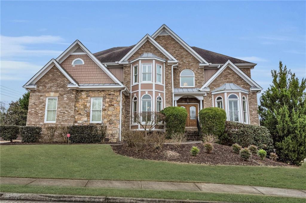 Presenting a remarkable executive home in the heart of West Cobb, Marietta, GA, featuring over 4,000 finished square feet and an additional 1,497 sq ft of unfinished basement space, providing endless possibilities for customization. Nestled in the top school districts, this brand new listing is situated in a highly desirable neighborhood, ensuring an exceptional education for your family.
Step into a world of spacious elegance as you explore the open and inviting floor plan. The large kitchen boasts granite countertops, a generous island, and modern appliances, making it a chef's dream. The expansive dining room and breakfast area offer ideal spaces for family gatherings and entertaining.
Relax in the airy living room with tall ceilings, creating a sense of grandeur and openness. The main level includes a full guest suite, perfect for accommodating in-laws or parents with ease and comfort.
Upstairs, discover four bedrooms, including a generously sized master bedroom with an attached large bathroom for ultimate relaxation and convenience. This executive home, crafted with 4-sided brick, stands as the original model for the community, showcasing unique and timeless design elements.
Situated on a coveted corner lot, this home features a 4-car garage – three on the main driveway and a fourth connecting to the unfinished basement. The level and spacious yard offer endless possibilities for outdoor enjoyment and activities.
With its perfect blend of size, style, and history as the community's original model, this property is the epitome of a perfect family home. Don't miss the chance to make this West Cobb gem your own.