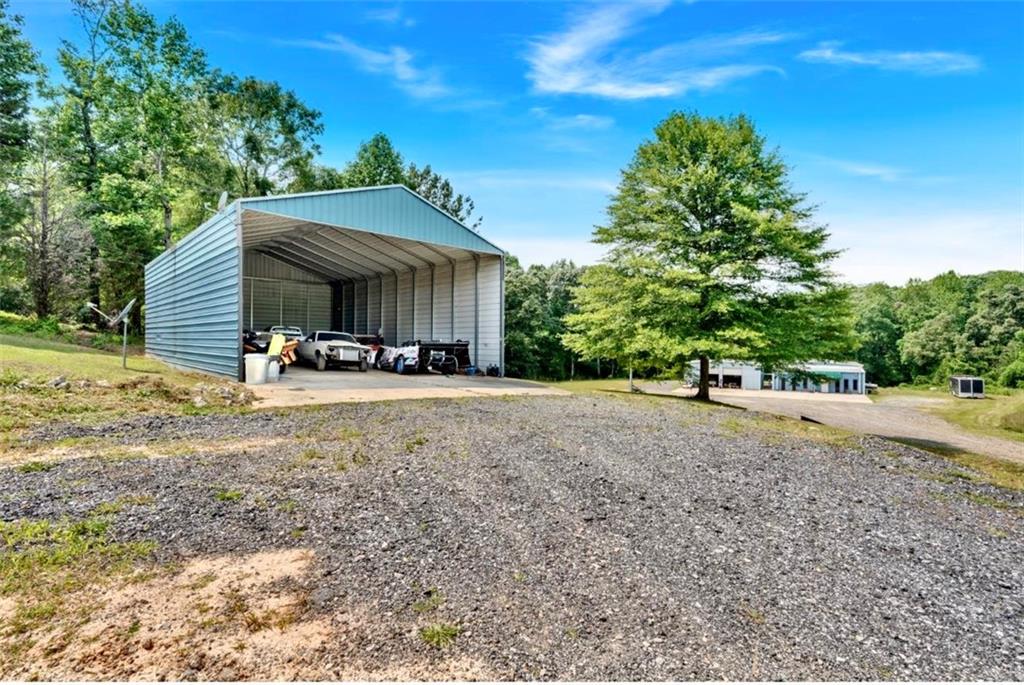 Expansive 5-Acre Property with In-Ground Pool, Shops, and Pole Barn - A Rare Find! Discover the perfect blend of space, functionality, and relaxation with this nearly 5-acre property offering endless possibilities. Whether you're seeking a private retreat, or a place to run your business from home, this unique listing has it all. The property features a beautiful in-ground pool, ideal for entertaining or enjoying quiet summer afternoons, equipped with power, water and septic tanks for those who may want to build on the frontage. For those who need workspace or storage, you'll love the two fully-equipped shops-perfect for projects, vehicles, or small business operations. The shop is an open canvas for business purposes or a potential barndominium style home! Additionally, there's a versatile pole barn with power, water, sewer hook ups! Enjoy the freedom of wide-open space, mature trees, and the tranquility of rural living while still being conveniently close to town amenities. With room to grow, build, or simply enjoy, this property is a rare opportunity you won't want to miss. Currently zoned residential but can be changed back to commercial?