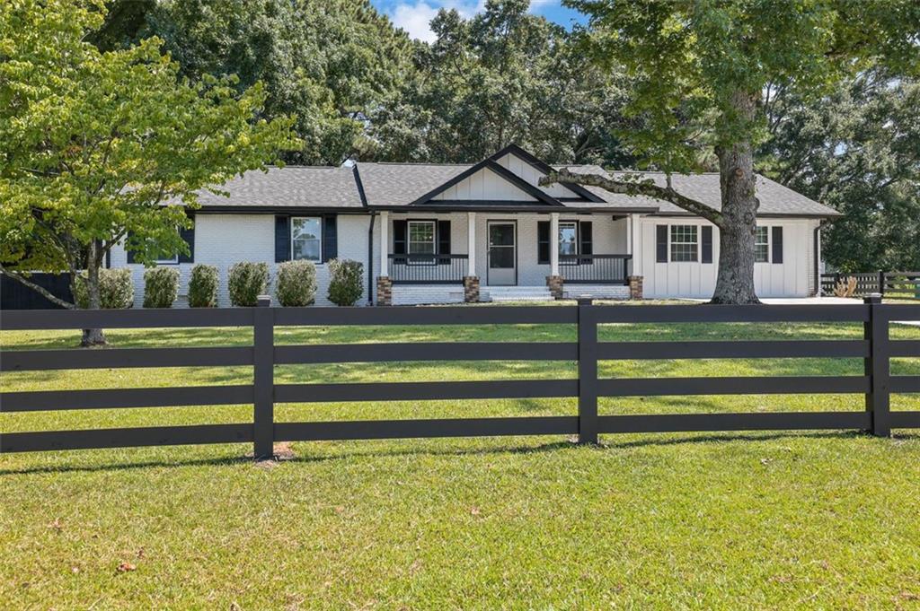 Stunning Fully Renovated 3-Bedroom Farmhouse-Style Ranch in Award Winning Brookwood School District Welcome to your dream home where timeless charm meets modern living. Nestled in one of Gwinnett County's most desirable and family friendly communities, this beautifully renovated farmhouse-style ranch is located in the top-rated Brookwood School District, known for its exceptional academics and close-knit community atmosphere. Every inch of this 3-bedroom, 2-bathroom home has been thoughtfully upgraded to offer both style and comfort. Step inside to discover: A brand new expansive bonus living room perfect for movie nights, entertaining guests, or easily converting into a 4th bedroom to suit your growing needs A light filled main living area featuring vaulted ceilings and a stunning modern fireplace, creating a warm, inviting atmosphere A gourmet kitchen designed for everyday living and entertaining, featuring solid wood cabinets, modern countertops, a designer sink and faucet, updated lighting, and a walk-in pantry An elegant separate dining room with a brand-new chandelier that makes every meal feel like a special occasion This home features high-tech, luxury vinyl flooring throughout-stylish, durable, and easy to maintain. Custom wood shelving in all closets adds a touch of craftsmanship and practical storage. Every major system has been upgraded for peace of mind: New roof New windows New toilets and fixtures Recently pumped septic tank with replaced septic lines (just 2 years old) Efficient HVAC system in excellent working condition Updated gutters and exterior finishes Enjoy the outdoors in your beautifully landscaped, fenced front and back yards-a safe and serene space for pets, kids, or quiet evenings under the stars. Whether hosting summer BBQs, playing with your children, or simply unwinding, this yard was made for memories. This home is truly move-in ready and offers the rare combination of modern upgrades, thoughtful design, and a location that supports long-term value all just minutes from top schools, parks, shopping, and dining. Your forever home awaits. Don't miss this rare opportunity schedule your private tour today!
