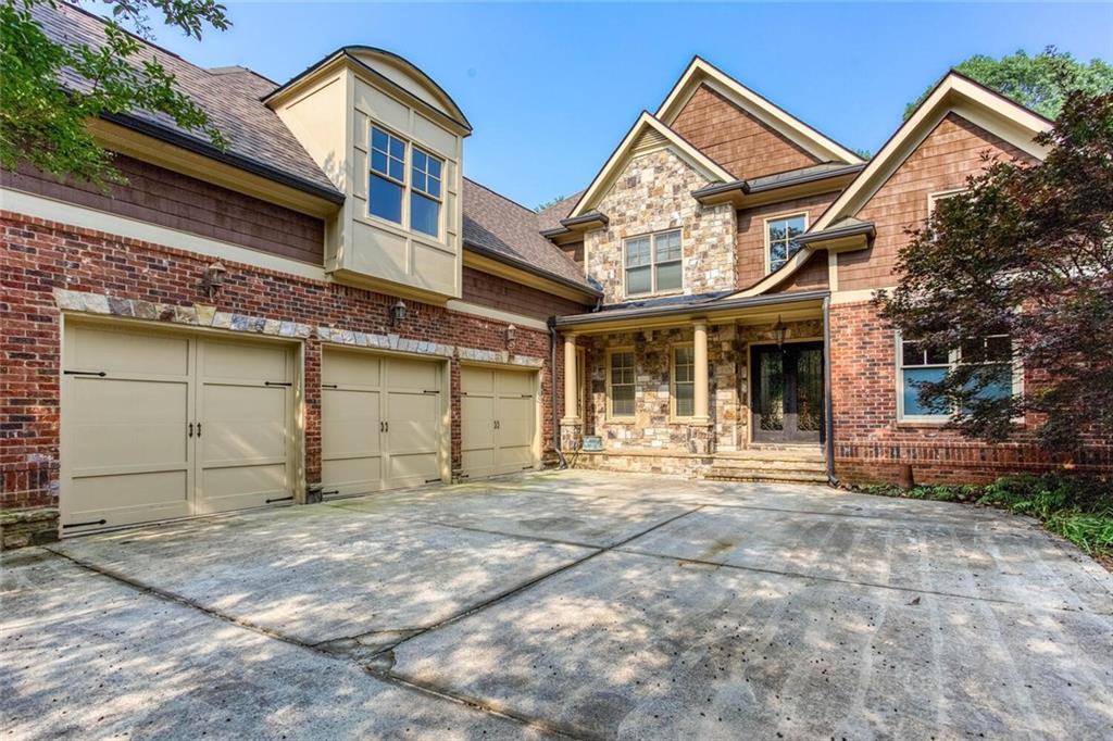 Introducing an extraordinary opportunity to own a meticulously crafted European-style estate just minutes from the highly acclaimed Pope High School. Perfectly positioned in one of East Cobb’s most coveted neighborhoods, this impressive all-brick residence blends timeless sophistication with modern luxury—offering an unparalleled lifestyle for the discerning buyer. From the moment you arrive, the stately curb appeal commands attention, with manicured landscaping enveloping the grand 4-sided brick façade and expansive 3-car garage. Step through the double doors into a soaring two-story foyer, where a sweeping staircase sets the tone for the refined interiors beyond. This expansive six-bedroom, five-and-a-half-bath home is thoughtfully designed for both everyday living and entertaining. The light-filled great room boasts elegant coffered ceilings and opens directly to a sweeping deck that overlooks a beautifully landscaped, private backyard—ideal for indoor/outdoor living. For those who work from home, the main-level office/library offers quiet sophistication, while the formal dining room and inviting fireside family room provide the perfect settings for hosting or relaxing. The heart of the home is a gourmet chef’s kitchen, equipped with top-of-the-line Wolf and SubZero appliances, custom cabinetry with accent lighting, double ovens, a farmhouse sink, and abundant counter space—perfect for entertaining with ease. The main-level primary suite is a true retreat, featuring a luxurious fireside bedroom experience, spa-inspired bath with soaking tub, oversized walk-in shower with sauna capabilities, and custom closets. Downstairs, the fully finished terrace level offers the ultimate in flexibility and comfort—complete with a home theater, private gym, and walkout patio. Designed with the future in mind, this home is also prepped for an elevator installation to seamlessly access all levels. Enjoy the best of East Cobb living—moments from top-tier schools, fine dining, boutique shopping, and community parks. Impeccably maintained and move-in ready, this exceptional property is the definition of luxury living. Schedule your private tour today and discover everything this extraordinary residence has to offer.