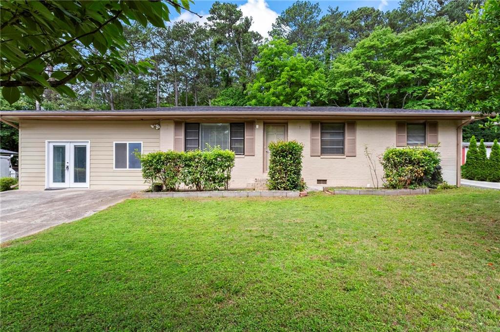 Renovated 4 bedroom, 3 full bathrooms, a second kitchen, and a converted garage ready for your home gym or for whatever extra space that may be on your needs list! Beautiful hardwoods, an abundance of light, stainless steel appliances, and a large, level backyard are just some of the stand-out features of this home. Great for multigenerational living with one bedroom, bath, and kitchen tucked in the back of the house. This property offers plenty of parking in the long, level driveway as well as a second parking pad for your RV or boat. Fantastic home for putting down roots or perhaps your next investment property. Easy access to the interstate in this super convenient Marietta location.