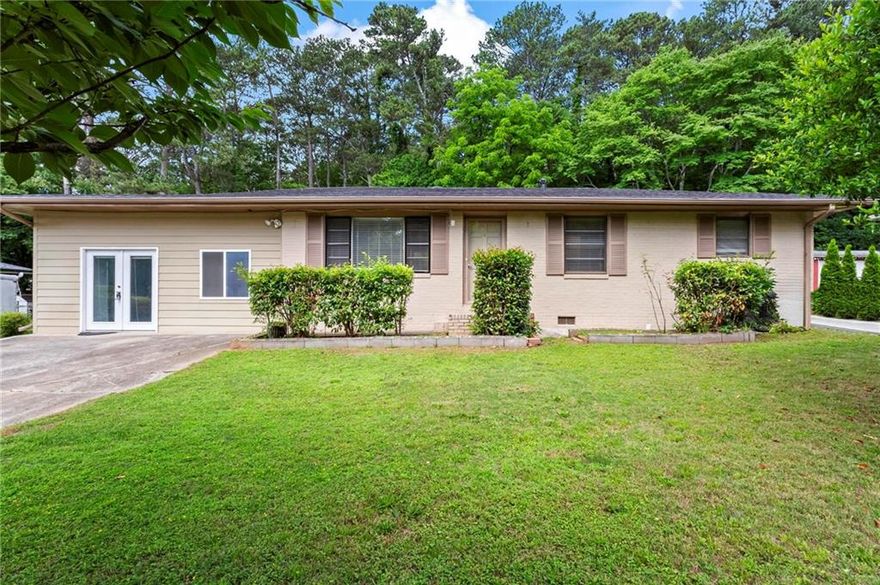 Renovated 4 bedroom, 3 full bathrooms, a second kitchen, and a converted garage ready for your home gym or for whatever extra space that may be on your needs list!  Beautiful hardwoods, an abundance of light, stainless steel appliances, and a large, level backyard are just some of the stand-out features of this home. Great for multigenerational living with one bedroom, bath, and kitchen tucked in the back of the house. This property offers plenty of parking in the long, level driveway as well as a second parking pad for your RV or boat. Fantastic home for putting down roots  or perhaps your next investment property.  Easy access to the interstate in this super convenient Marietta location.