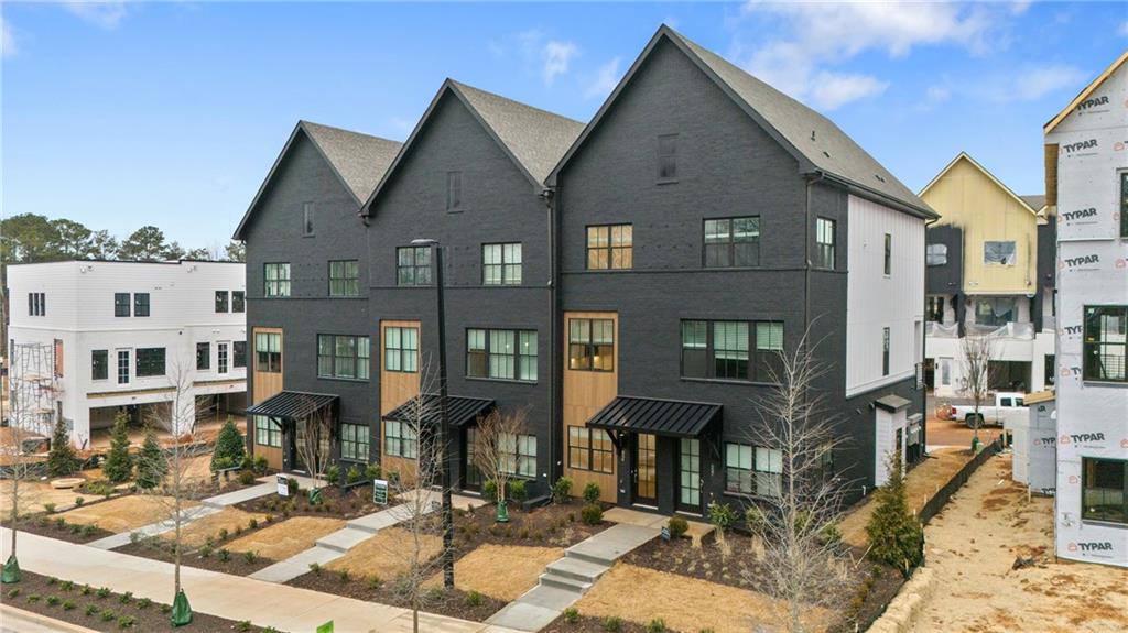 Welcome to The Anniston at The Gathering, a stunning Contemporary style townhome designed for modern living. This beautifully crafted home offers 1,644 square feet of thoughtfully designed space, features two bedrooms, a flex space, and three luxurious bathrooms, perfectly blending comfort and style. As you enter the Anniston you will find a versatile terrace level that includes a cozy flex space, a full bathroom, and convenient access to the garage. Ascend to the main living area on the second floor, where 10-foot ceilings and an open-concept layout seamlessly integrates the kitchen, dining area and living room. The gourmet kitchen showcases quartz countertops, KitchenAid appliances and maple cabinetry. This space is perfect for entertaining guests or enjoying a quiet evening at home. Step out onto the deck off the living area to enjoy fresh air and outdoor relaxation. The third floor is dedicated to restful retreats. The primary suite boasts a walk-in closet and a well-appointed bathroom featuring double vanities, quartz countertops and a glass shower providing a serene sanctuary. A second bedroom, complete with its own full bath, offers comfort and privacy for family members or guests. The Gathering is a vibrant new community, just minutes from downtown Alpharetta, Avalon and top-rated schools as well as prime access to the Alpha Loop. This home provides the ultimate in modern suburban living. Experience the perfect combination of style, comfort and convenience!! This home is estimated to be complete by February 2025. The photos in the listing are not images of the actual home. This is offered as representation of the floorplan and colors/design will vary.