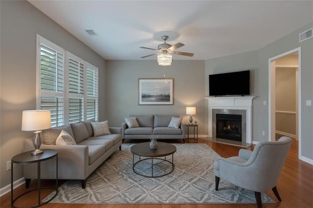 Welcome to this beautiful 1,985 sq. ft. townhouse located in a private, gated, and impeccably maintained community. Inside, you'll find an open floor plan with rich hardwood floors, granite countertops, and all stainless steel appliances—including a modern touchscreen refrigerator. The cozy fireplace lights instantly with the flip of a switch, adding warmth and charm to the living space. Upstairs features a spacious master suite and a versatile office nook or sitting area conveniently located in the hallway—perfect for remote work or quiet reading. With a 2-car garage and a spotless, move-in-ready interior, this home offers modern comfort in a serene, secure setting.