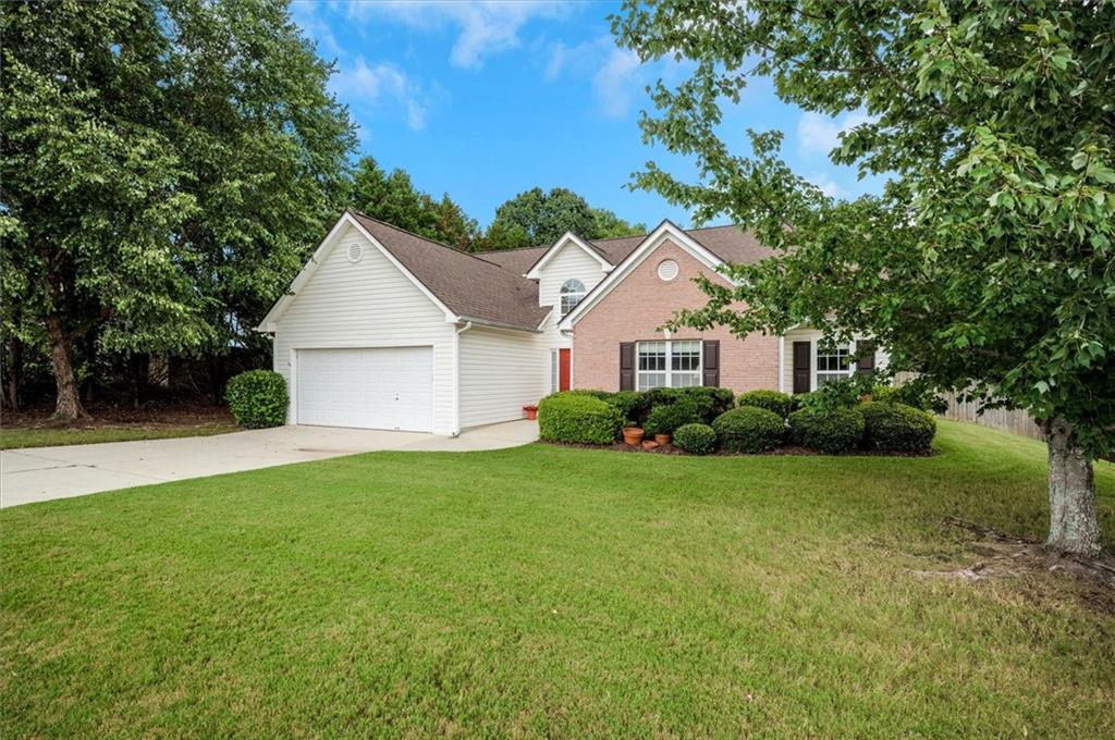 Charming Ranch Retreat. Welcome to this beautifully maintained 3-bedroom, 2-bath ranch home nestled in a quiet, established neighborhood in the heart of Dacula. Whether you're a first-time buyer, downsizing, or simply looking for easy, single-level living, this home offers the perfect combination of comfort, privacy, and convenience. From the moment you arrive, you’ll be greeted by a warm, inviting exterior and lush landscaping. Step inside to discover an open, light-filled floor plan with vaulted ceilings, a spacious living room with a cozy fireplace, and a separate dining area perfect for entertaining.The updated kitchen features plenty of cabinet space, stainless steel appliances, a breakfast nook, and a view to family room—making meal prep and family time easy and enjoyable.
The primary suite is a peaceful escape, complete with a walk-in closet and an en suite bath featuring dual vanities, a soaking tub, and a separate shower. The star of the show is the sitting area/nursery space/exercise space or just a peaceful retreat in your primary room. Two additional bedrooms and a full bath provide ample space for family, guests, or a home office. Step outside to your own private oasis—a fully fenced backyard with a large patio, mature trees, and plenty of green space for kids, pets, gardening, or weekend BBQs.