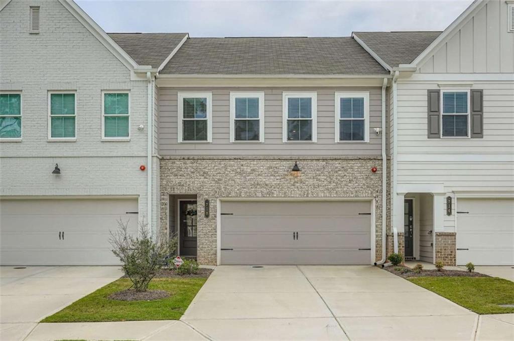 Discover the perfect blend of style, comfort, and convenience in this Nearly NEW 2023-built townhome, located in the sought-after Gates at Hamilton Grove. Step inside to soaring ceilings, abundant natural light, and luxury finishes throughout. The open-concept floor plan is designed for both everyday living and effortless entertaining, featuring durable luxury vinyl plank flooring on both levels, a chef's kitchen with quartz countertops, stainless steel appliances, sleek white cabinetry, a walk-in pantry, a large center island, and a chic herringbone subway tile backsplash. The kitchen flows seamlessly into the living room and breakfast area with direct access to the private patio, creating an ideal indoor-outdoor connection. Upstairs, the loft offers flexible space perfect for a home office, study nook, or play area. The owner's suite is a true retreat with a sitting area, spa-inspired bath with double vanities, a glass and tile shower, and an oversized walk-in closet. Two additional spacious bedrooms share a beautifully appointed full bath, providing options for guests, a gym, or a second office. A convenient upstairs laundry room and two-car garage complete the home. Residents enjoy community amenities including a pool, playground, fire pit, and open green spaces designed for relaxation and connection. This location offers unmatched access to shopping, dining, and recreation with Town Center Mall, Historic Marietta Square, Kennesaw Mountain National Park, The Battery Atlanta, Kennesaw State University, and Kennestone Hospital all nearby. With quick access to I-75, I-575, and US-41, commuting throughout Metro Atlanta is effortless. 718 Trevett Way is turnkey, stylish, and ideally located in one of Marietta's most vibrant and convenient communities-don't miss your opportunity to call it home.