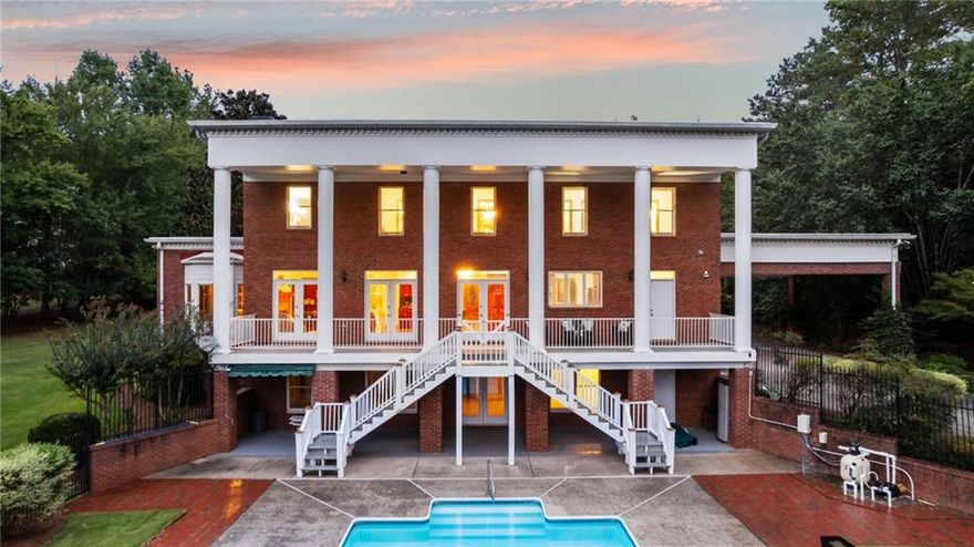 Discover one of the largest and most private home sites near downtown Milton with 3.82 acres of serene, unrestricted living with no HOA. This picturesque Southern Colonial estate offers the perfect blend of charm, self-sufficiency, and elegance. Imagine gathering fresh eggs from your own chicken coop, growing an organic garden, steps from your back door, and watching your animals roam freely, all while being just minutes from Milton and Crabapple’s shops, schools, and restaurants. The open greenspace, mature trees, natural pond, and fenced saltwater pool create an inviting backdrop for outdoor living. Whether you dream of a thriving vegetable garden, a small hobby farm, or simply a quiet retreat surrounded by nature and wildlife, this property offers the space and freedom to make it happen. Meticulously designed by its original owners, who handpicked the plan from Colonial Homes Magazine, this Southern Colonial Greek Revival features timeless craftsmanship and thoughtful details throughout. Highlights include: Spacious and versatile living areas with multiple wood-burning fireplaces and custom millwork. Gourmet kitchen with Cherry cabinetry, granite countertops, stainless steel appliances, large island with cooktop, wine cooler, and oversized walk-in pantry. Elegant entertaining spaces including a large Formal Dining Room with Brick Fireplace, Butler’s Pantry and copper sink. The Peaceful owner’s suite with French doors, soaking tub, separate tile shower, double vanity, and walk-in closet. Finished basement with full bath and direct pool access, perfect for guests or entertaining. The detached 2-car garage features a large workshop that is ideal for wood working or storing items for your homestead. The finished living space above, ready for a guest suite, studio, or home office is stubbed in for a kitchenette, full bath and laundry area. Enjoy evenings on the covered deck overlooking the pond and take in the stunning sunset views while grilling out, the gas line already in place. The large circular driveway offers ample parking for gatherings, equipment or an RV. This is more than just a home — it’s a lifestyle. A place where you can live off the land, raise animals, garden, and breathe deeply in your own private sanctuary, free from HOA restrictions. Come experience the best of both worlds: the peace of rural living and the convenience of downtown Milton just minutes away. Your dream homestead awaits!