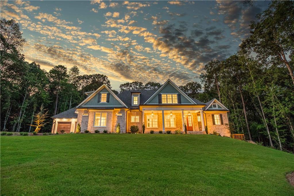 Stunning New Construction on 2.29-Acre Lake Lot in Gated Community! Welcome to luxury lake living in this exceptional 4-sides brick home, nestled on a spacious 2.29-acre lot in a gated community featuring a private boat ramp and pavilion. With the option to build your own dock, this lake lot offers the perfect blend of privacy, functionality, and upscale design. This thoughtfully designed home features 4 bedrooms and 4.5 bathrooms with an open floor plan ideal for entertaining. The chef's kitchen is the heart of the home, boasting a large working island, quartz countertops, custom tile backsplash, farmhouse sink, and high-end stainless steel appliances including a gas cooktop, decorative hood, double ovens, microwave, and dishwasher. The main-level owner's suite is a relaxing retreat complete with a soaking tub, large tiled shower, double vanities, and elegant tile flooring. The formal dining room showcases coffered ceilings, while the spacious family room centers around a beautiful stone fireplace and is accented by soaring floor-to-ceiling windows that flood the space with natural light. Upstairs, you'll find three oversized bedrooms, each with its own private en-suite bath. Additional highlights include hardwood, tile, and carpet flooring throughout, a 4-car garage, irrigation system, and landscape lighting for added appeal. This home offers luxury, space, and the lake lifestyle don't miss your chance to make it yours!