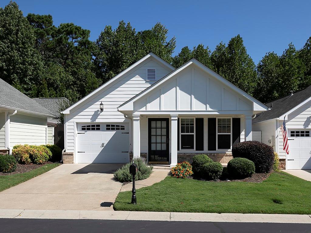 Welcome to Montclair at Ridgewalk, a Windsong Property. Come visit this small, quiet community in Woodstock. The neighborhood consists of charming, low-maintenance homes surrounded by immaculate landscaping. This beautiful stepless newly painted 2 bedroom, 2 bath ranch home is amazing! Hardwood floors throughout and new carpet in the bedrooms/family room. This lovely ranch has an open family room with lots of natural light, inviting foyer area, large open kitchen with breakfast room, a breakfast bar, cherry cabinets and newer countertops and pantry. Kitchen has an electric stove/oven. But, don't worry it can be switched over to gas. Laundry closet is off the kitchen. Vinyl tile garage floor. And, enjoy the large primary suite with sitting room/office with ensuite bathroom, double vanity, shower and the perfect walk-in closet with custom built shelving and wardrobe space. This is definitely a must-see! Across the hall is the guest bedroom with a full bath. And, for the outdoor enthusiast, take in the private courtyard/side porch area with arbor. Perfect for gardening or outdoor entertaining with friends and family. And, don’t forget to check out the Communities Clubhouse which includes a fitness room, library, and a sitting room where homeowners can visit with their neighbors or enjoy watching the large-screen TV. The subdivision, located within walking distance to the Outlet Shoppes of Atlanta, is just minutes from highways 575 and 92. It is also a short drive to historic downtown Woodstock, numerous stores and restaurants. And lastly, Woodstock offers easy access to downtown Atlanta to the south and the Georgia Mountains to the north. Living at it’s very best!