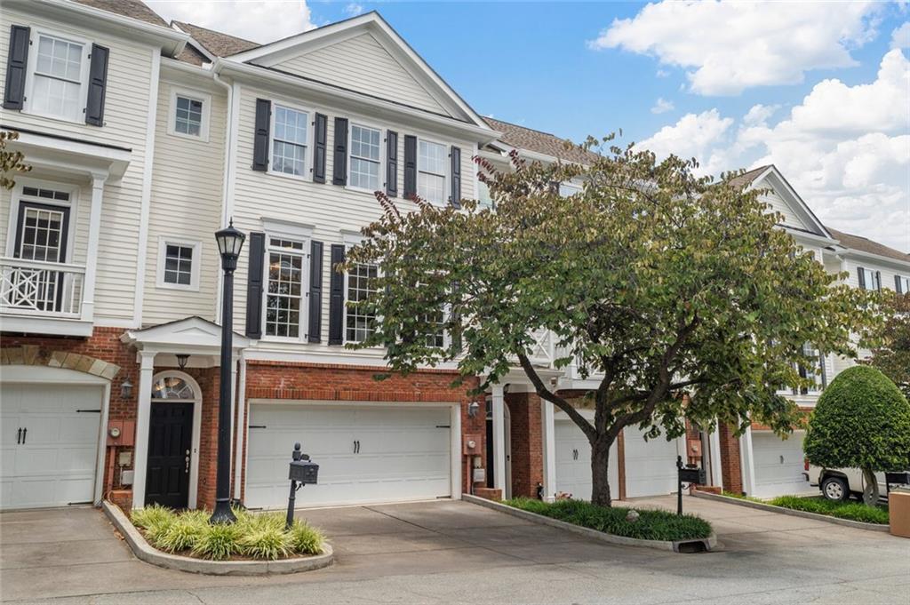 THE Perfect Blend of Style, Nature & Walkable Charm in the Heart of Roswell. The lifestyle you've been waiting for in this beautifully UPDATED 3 bedroom, 3.5 bath townhome nestled in a gated Roswell community. With FRESH PAINT Inside & Out & HARDWOOD Floors Throughout, this home effortlessly combines comfort & sophistication. The inviting kitchen features stainless steel appliances, painted cabinets, granite countertops, and an oversized walk-in pantry, offering both style and functionality. The main level also features a spacious great rm w/fireplace & a wall of windows that bathes this space in natural light. The spacious primary suite features an UPDATED PRIMARY BATH w/soaking tub and tiled shower that adds a luxurious touch to your private retreat. The show-stopping terrace level is designed to impress—complete with a custom bar, wine wall, and full bath—ideal for hosting guests or creating your own personal escape. Whole House Water Filtration System. Step outside & enjoy unparalleled walkability to artisan coffee shops, local eateries, yoga studio, and scenic hiking trails. Enjoy the ease of a FULL-WIDTH garage door—no awkward maneuvering between narrow single bays. Only a short stroll to the Roswell Mill, Chattahoochee Nature Center, Vickery Creek Trail, and the historic beauty of Barrington Hall. When it's time to unwind or socialize, head to vibrant Canton Street for boutique shopping, art galleries, and acclaimed restaurants. Community events like the Roswell Wine Festival and Alive in Roswell’s Thursday gatherings keep the energy alive all year round. Where elevated living meets everyday adventure—welcome to your Roswell retreat.