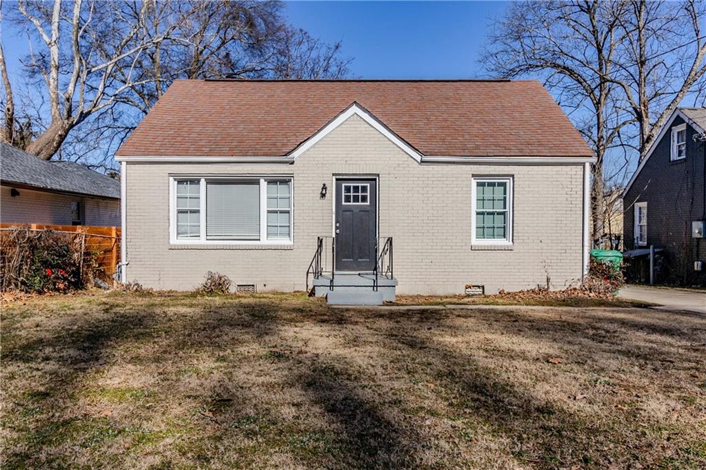 Bungalow-style house with a front lawn