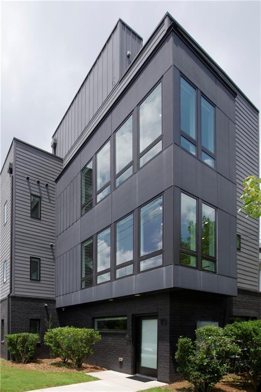 Welcome to luxury and convenience in Lake Claire near great dining, entertainment, and shopping as well as the Beltline and Krog Street. Minutes from Inman Park, Old Fourth Ward, and Candler Park. Exquisite finishes and modern style grace this three level townhouse with a large rooftop patio. The open concept main level features a kitchen with Viking Appliances and elegant style. Balconies and picture windows fill the space with natural light. An oversized pantry with built-in shelves and cubbies make storage easy and convenient. Six bathrooms, four full bathrooms and two powder rooms, provide easy access for you and your guests. Abundant, roomy closets and two-car garage provide ample storage. A bonus family room on the lower level features a wine fridge and a wet bar. All six bathrooms are finished with an eye for detail. The rooftop patio adds even more space for entertaining or enjoying the views of Atlanta. The main level includes an office or flexible use space in addition to the four bedrooms. Internet, lawn maintenance, and trash included in rent. Elementary School: Mary Lin. Middle School: David T Howard. High School: Midtown.