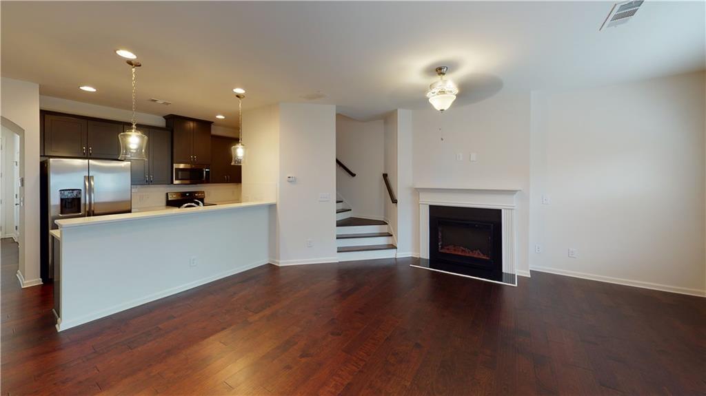 Absolutely exquisite! Presenting an exceptional opportunity to rent a stunning townhome with a 1-car garage in the thriving Decatur area. This residence is nestled within a gated community, offering an exclusive living experience. Step inside and be greeted by a true culinary masterpiece – a Gourmet Kitchen adorned with sleek quartz countertops and an array of top-of-the-line stainless steel appliances, including a refrigerator and washer/dryer ensemble. The kitchen seamlessly flows into the Living/Dining Room, where a cozy fireplace sets the perfect ambiance for both relaxation and entertainment. Enhancing the allure of this space, hardwood floors gracefully extend throughout the lower level. Retreat to the Master Bath, a sanctuary of elegance and comfort. Dual vanities with exquisite countertops, upgraded tile floors, a rejuvenating jetted garden tub, and a separate glass-enclosed shower with a built-in seat create an indulgent spa-like experience. Step outside and experience an oasis of tranquility in your fully fenced backyard, complete with a delightful patio. The HOA takes care of the yard maintenance, allowing you to relish the outdoor space hassle-free. Conveniently located near major highways 285/20, this townhome offers seamless connectivity. And that's not all – a plethora of thoughtful upgrades enhance the charm and value of this remarkable property.