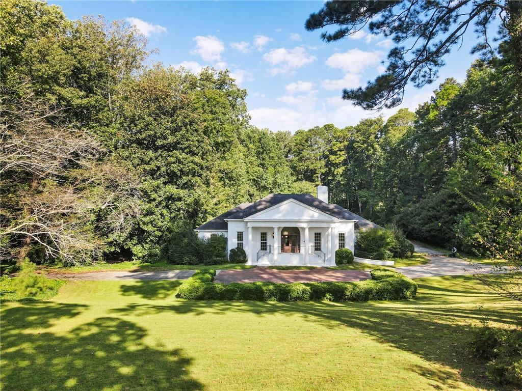 LOCATION LOCATION LOCATION!!! Sope Creek, Dickerson AND Walton school districts. This house is perfect for high end remodel/flip. Come be creative and make the best use out of these RARE 3.9 acres on Paper Mill Road/Corner lot with two road entries. Investors welcome.