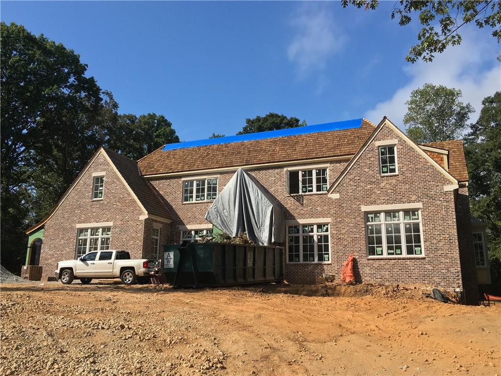 Extraordinary New Estate on Private One+ Acre Level Lot w Pool & Spa in one of Buckhead’s Most Coveted Quiet Walkable Neighborhoods! Timeless brick and limestone exterior with cedar roof. 2 meticulously planned levels featuring gray limestone foyer, wine room, 20’ vaulted great room with custom fireplace which opens to State-of-the-Art Kitchen with iron doors and windows. Two Master Suites. Covered loggia, outdoor kitchen and fireplace. Cabinetry by Kingdom Woodworks. 4 Car garage. This home offers all the amenities for the ultimate in family living and entertaining.