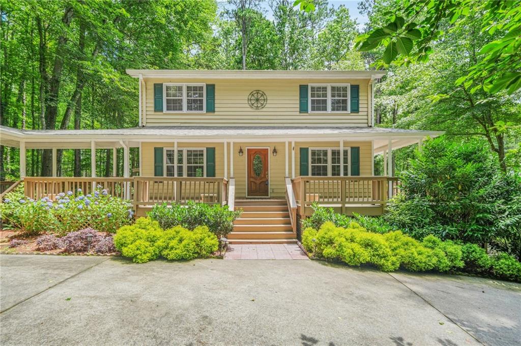 Lakeside oasis on 1.7, private acres in the heart of Marietta! Enter across the breezy, wraparound porch and turn to look across the private and beautifully landscaped front yard. Step through the front door to find the open concept living space, which offers an fireside family room, a formal dining room and an office that could be converted to an additional guest bedroom. Follow the hardwoods to the eat in kitchen with it's new, stainless stove and microwave, an abundance of knotty pine cabinetry and an eat in / breakfast area. Pass through the kitchen to yet another living space...an oversized great room with a vaulted ceiling and stacked stone fireplace. Make your way upstairs to the owner's suite with its updated ensuite bath. Two additional bedrooms and a full bath round out the upstairs. On the lower level, find another living and/or recreation space, including a large family room, guest space, plenty of finished and unfinished storage and a full bath with a new sink and shower. The best is still yet to come! Walk out onto the huge, screened back deck and look out over paradise. This is the best of outdoor living! Envision yourself enjoying morning coffee or an after work beverage on the enclosed porch and in the privacy of the trees, as you look out over your own, secluded lakefront. It doesn't get better than this. All of that and the peace of mind that comes with a new roof, new Aquaguard, gutter system and new garage door openers that go with the detached, two car garage. Don't miss the opportunity of enjoying your own, lakefront retreat in beautiful Marietta!