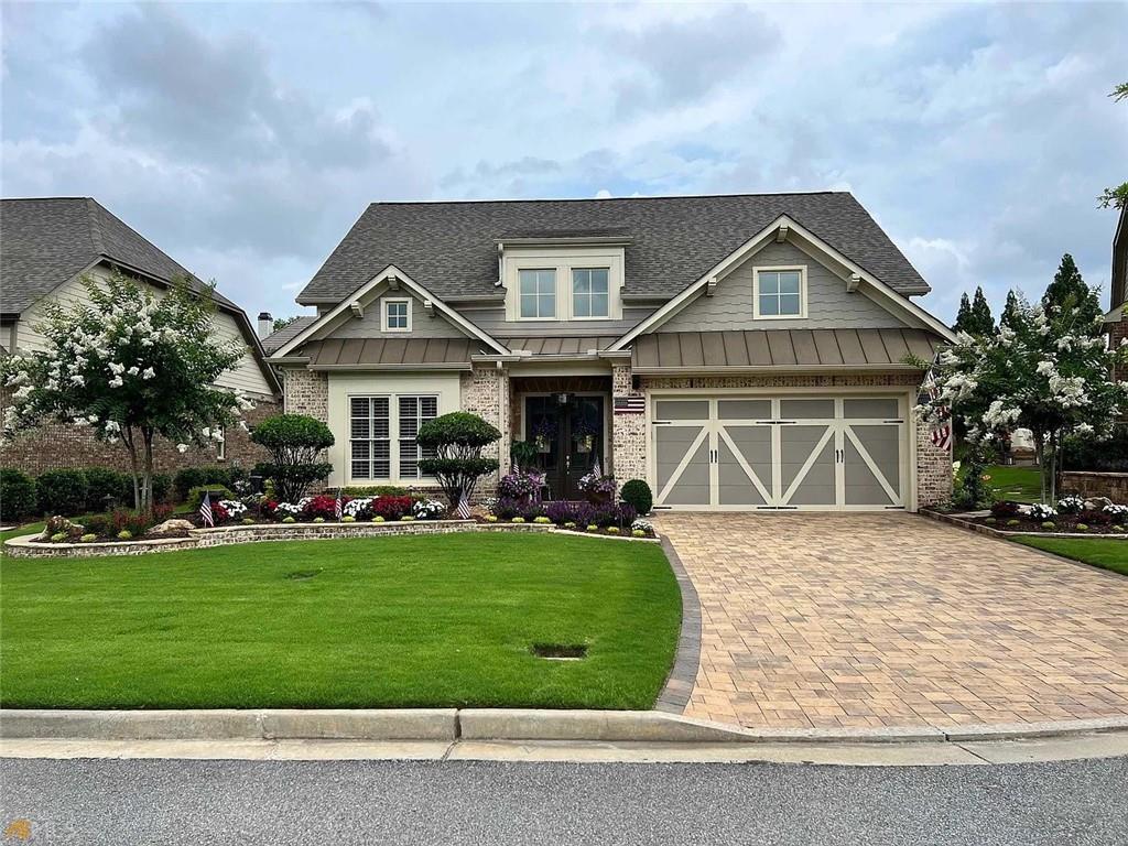 Welcome to your dream home in this highly desirable gated Active Adult community of just 40 residences! This exceptional property is filled with upgrades and custom touches throughout, offering the perfect blend of elegance, comfort, and convenience.
From the brick paver driveway and stone walkways to the manicured landscaping and stepless entry, every detail has been thoughtfully designed. Inside, you’ll be greeted by soaring ceilings, French Oak hardwoods, detailed moldings, and designer finishes that make this home truly stand out.
The open-concept floor plan is ideal for both entertaining and everyday living. The gourmet kitchen boasts stainless steel appliances, custom cabinetry, Cambria countertops, oversized island, tile backsplash, skylights, and a walk-in pantry—truly the heart of the home. The fireside family room with custom built-ins flows seamlessly into the banquet-sized dining area.
The main-level owner’s suite features a spa-like bath with frameless shower, dual vanities, and a large custom walk-in closet. Two additional bedrooms and a full bath are also located on the main floor. Upstairs, a spacious loft and private ensuite bedroom provide the perfect flex space for guests, work, or play.
Practical upgrades include a large laundry room with custom cabinets and sink, a two-car garage with painted granite floors and EV wiring, and abundant storage throughout.
Step outside to your own private retreat—a stunning closed-in patio with a vaulted ceiling, gas fireplace, and ceiling fan. The fenced backyard is perfect for gatherings, complete with an outdoor kitchen, grilling station, refrigerator, and built-in speakers.
Lawn maintenance is included, allowing you more time to enjoy the lifestyle this community offers. Just minutes from GA-400, Halcyon, and The Collection, this property combines convenience with luxury living.
Don’t miss the chance to make this exceptional home yours!