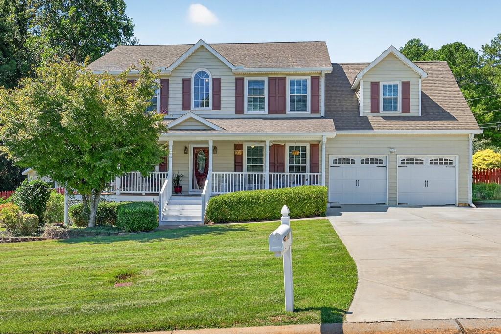 Charming Traditional Home on a Corner Lot - Welcome to this beautifully maintained 4-bedroom, 2.5-bath home offering timeless style & modern comfort. The oversized master includes a private sitting room that could easily serve as a 5th bedroom, nursery, or home office. The spa-like master bath features dual vanities, separate shower/soaking tub. Hardwood floors flow throughout the main level, complemented by fresh paint for a move-in ready feel. A separate dining room & living room provide plenty of space for entertaining or the perfect setup for a private office. Enjoy quiet evenings on the large screened-in porch overlooking the spacious, fenced backyard—ideal for gatherings, or kids. The inviting covered rocking chair front porch adds to the home’s curb appeal & charm. Located in a quiet neighborhood near the end of a cul-de-sac, this home sits on a beautiful level corner lot. Minutes from shopping, dining, & Coolray Field, you’ll enjoy both privacy & convenience. Don’t miss this opportunity—schedule today!