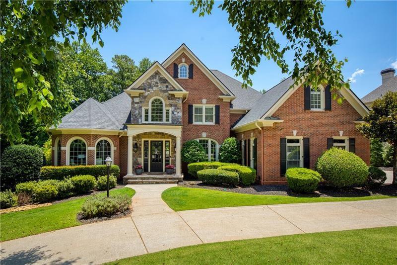 Exquisite and beautifully updated home nestled in the exclusive Northshore neighborhood of Windward! This elegant residence overlooks the 16th hole on The Lakeside course of the prestigious Golf Club of Georgia, a 36-hole award winning course designed by Arthur Hills. Step inside to discover the designer touches and updates throughout this light and bright home from the gracious two-story entry to the oversized formal dining room with custom wallpaper and draperies, to the home office with floor to ceiling built-ins. The formal living room showcases a park like setting with a wall of new windows, custom built-ins and a gorgeous stone fireplace. The kitchen was updated in 2019 and is a chefs dream with luxury stainless steel appliances, ample work space and a walk-in pantry. Enjoy the recent addition of the coffee and wine bar and extra cabinetry while dining in the kitchen or relaxing in the generous keeping room. The luxurious primary suite is located on the main floor and offers amazing backyard views, natural light and access to the deck. The spa-like primary bath was updated in 2019 and features an oversized soaking tub, large marble shower and double vanities as well as a large walk-in closet with custom built-ins. Two elegant staircases bring you to the second floor where you will find 4 generously sized bedrooms all with ensuite baths, built-ins and large walk-in closets offering the perfect blend of comfort and luxury! The daylight terrace level of the home was updated in 2024 and is an entertainer's delight! This level features a full custom bar with wine cellar, dining area, large family room, and full bathroom not to mention gaming areas, a gym and guest quarters. The terrace level also provides direct access to the new covered patio, outdoor kitchen and dining spaces. There are 3 gorgeous gas stone fireplaces throughout this home! The picturesque, fenced-in backyard is not only serene but is pool-ready and provides plenty of privacy. This home is well suited for multigenerational living at its finest! Additional updates include, new roof in 2024, 2 hot water heaters replaced in 2021, 2 new HVAC's in 2022 & 2023. Enjoy boating, fishing and kayaking in the beautiful Lake Windward, a 195 acre lake in the heart of the community! The Windward Lake Club offers 4 pools, tennis courts, pickleball, a marina, playgrounds and a sports park. In addition to the Windward amenities, the Northshore neighborhood is the only gated neighborhood in Windward with 24/7 security. The Northshore has its own private swimming pool, tennis, pickleball, and basketball courts...truly a private community within a community! Just a few minutes to GA 400, Avalon, Halcyon, Downtown Alpharetta with top notch schools plus access to the Greenway, this community is the most highly desired in Alpharetta! Proof of funds required for showings. Buyers have the opportunity to purchase the home’s furnishings for a complete move-in ready experience.