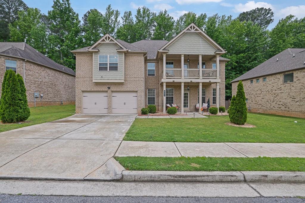 STOP THE CAR!!! This Stunning 4-Sided Brick Beauty in the Highly Coveted Baycreek Gated Community is waiting for its next perfect Owner! Welcome to the elegance, comfort, and space in the award-winning Loganville School Cluster. This 5-bedroom, 4-bathroom home has it all—perfectly blending luxury and functionality. From the moment you arrive, the inviting rocking chair front porch sets the tone. Step inside to gleaming hardwood floors and a grand foyer flanked by a formal dining room with coffered ceilings and custom crown molding. Across the hall, a spacious guest suite with a full bath offers the perfect retreat for in-laws or visiting guests. The expansive family room flows seamlessly into a chef’s dream kitchen featuring a MASSIVE island, stainless steel appliances, granite countertops, an oversized walk-in pantry, and ample cabinet space. Entertain in style with a separate butler’s pantry and built-in wine rack—ideal for hosting or crafting your favorite cocktails. Upstairs, prepare to be amazed by the truly oversized master suite, complete with a large sitting room—perfect for a home office, nursery, or personal gym. The luxurious en-suite bath boasts a dual vanity, soaking tub, custom tile shower with glass enclosure, and a dream master closet with direct access to the laundry room for ultimate convenience. Three additional spacious bedrooms upstairs offer soaring cathedral ceilings, walk-in closets, and access to two more full bathrooms. One bedroom even opens to its own private balcony—your perfect spot for morning coffee or quiet evenings. All of this is situated on a level, flat lot in a beautifully maintained and gated community, just minutes from top-rated Baycreek Elementary and Loganville schools. Homes of this size and quality rarely come on the market—don’t miss your chance to make this DREAM home YOUR reality! Schedule your showing today!