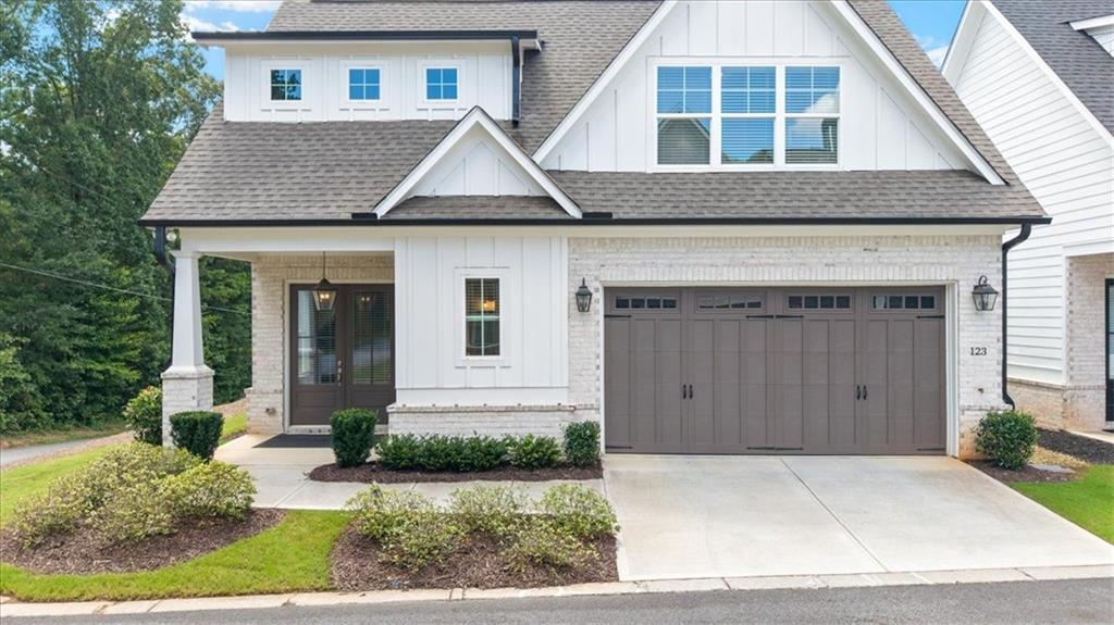 Light and Bright, 3 Bedroom/3.5 Bath located in The Enclave at Wiley Bridge. This Like-New, 2023 Construction welcomes you with a Covered Front Porch. Offering Contemporary and Open Concept living, packed with luxury upgrades, including Custom windows, closet shelving, built-in Cabinetry and Hardwood Floors throughout the main level. The Chef’s Kitchen includes an expansive Island with upgraded Quartz countertops, Stainless Steel appliances and Walk-In pantry. The Spacious Dining and Family Rooms feature a cozy gas Fireplace and a wall of windows that fills the home with natural light. The private and covered outdoor Patio is perfect for entertaining. There are two Bedrooms on the main level, including the Primary Suite, featuring a double vanity, gorgeous oversized shower, with seating and glass surround. A separate laundry room, as well as ample closets are conveniently located as you come in the home from the 2 car garage, equipped with an Electric Car Charger. Upstairs features an additional Oversized Bedroom Suite. Turnkey and Nestled on a Low-maintenance and Professionally Landscaped End lot in a beautiful wooded community of 24 homes. Top Rated and Award Winning Schools - Arnold Mill Elementary, Mill Creek Middle, River Ridge High School. Convenient Proximity to Historic Downtown Woodstock and Roswell, Alpharetta, 575 and 92. Easy access to Hospitals and Park, and Limitless Shopping and Dining. Schedule your private tour today and experience the best of Woodstock living! Private showings by appointment only through Showing Time.