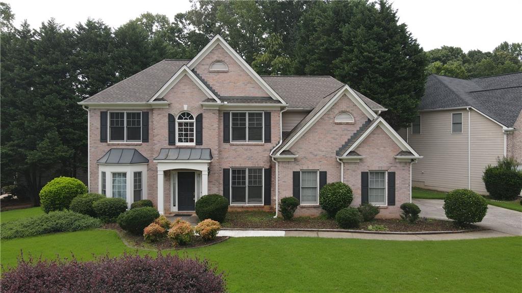 Move-In Ready. A Beautiful 4BR/3BA home located in the sought after North Gwinnett cluster. Hardwood flooring throughout on main. Open concept granite island kitchen w/walk-in pantry views large family room. Master suit features a spacious walk-in closet and an open master bath with sep tub and shower and his and hers vanities. 3 more bedrooms with ample walk-in closets. Separate dining room. Well maintained. Corner flat lot. This an Unbeatable Swim/Tennis Club Community offering Activities for the Entire Family. Incredibly Convenient Location Close to lots of activities, restaurants and shopping!