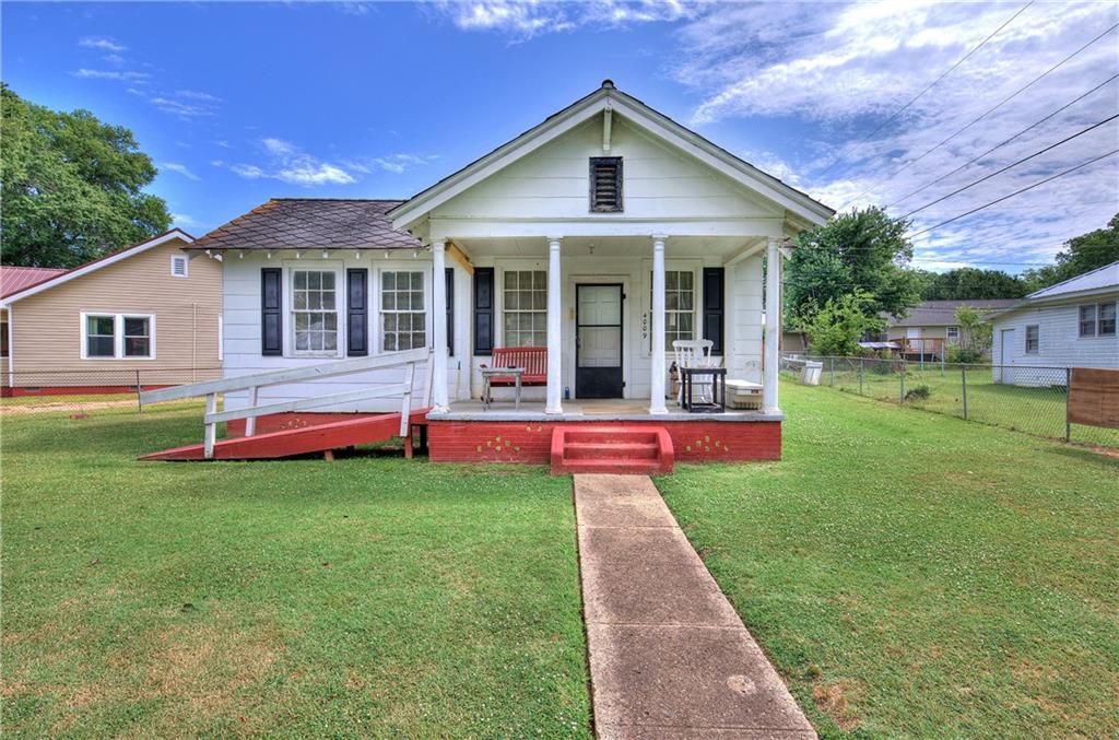 Adorable bungalow with TONS of potential! Tall ceilings, beautiful stone fireplace, large kitchen - open concept. Fully fenced yard- great location! Cash or conventional only please! Home is occupied.