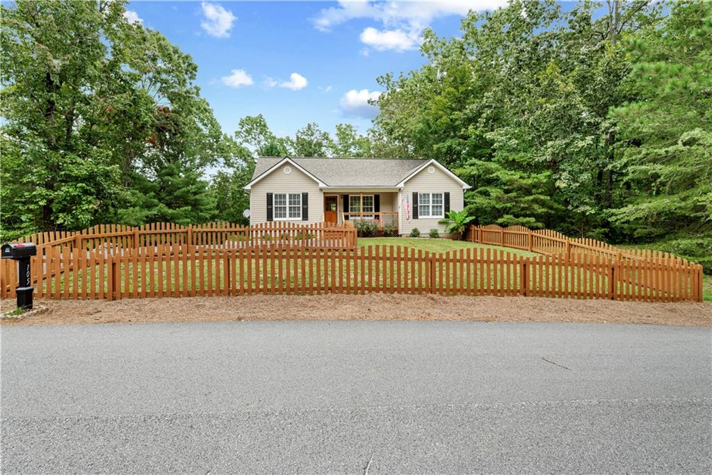 Step into an impeccably renovated home that offers the sleek comfort of brand-new construction offered at resale pricing. Experience the perfect blend of contemporary living and serene natural beauty in this renovated split bedroom plan home which includes 4-bedroom, 3-bath, nestled on a picturesque 1.3-acre lot in the sought-after community of Dahlonega. Every inch of this residence has been thoughtfully updated, featuring brand-new flooring, carpet, a modern open-concept kitchen equipped with state-of-the-art appliances, and elegantly remodeled bathrooms. 3 bedrooms and two baths on the main level with the lower level offering a versatile retreat, complete with a spacious bedroom, a full bathroom, an additional flex room and a dedicated workshop for the hobbyist and/ or DIYer — Step outside to discover a double-tiered deck that overlooks a tranquil, wooded backdrop, offering the perfect setting for morning coffee or evening gatherings. Significant updates include a new roof installed in 2020, a 2024 HVAC system, and an additional brand-new unit, ensuring year-round comfort and energy efficiency. Don't miss this opportunity to own a move-in-ready home that combines modern amenities with the peaceful ambiance of mountain living. Minutes from restaurants and shopping. Schedule your private tour today and envision the lifestyle that awaits you in this exceptional Dahlonega residence.