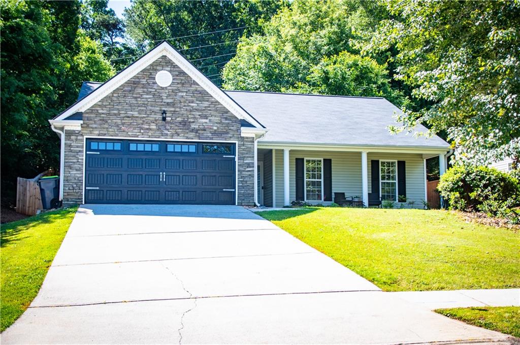 This meticulously maintained ranch home is just a short walk from downtown Villa Rica, the "City of Gold." Located on a corner lot, 331 Berkley Drive offers 3 bedrooms and 2 baths, including a master suite with a tray ceiling, garden tub, separate shower, and walk-in closet. NEW GRANITE COUNTERTOPS throughout the home and a host of other upgrades, including stainless steel appliances, a new garage door with MyQ technology, new flooring, and fresh interior paint, make this home truly shine. Outdoors, enjoy a cozy front porch, a large covered patio, and a new wood privacy fence. This peaceful neighborhood features a community pool, playground, and pavilion, and the nearby Mill Amphitheater hosts year-round festivals, concerts, and events. SO MANY ADDITIONAL UPGRADES IN THE LAST YEAR: back yard cleared and expanded, wood privacy fence, new flooring in bedrooms, attic storage added, kitchen and bathroom floors tiled, interior paint, updated thermostat, new doorknobs and hinges, ceiling fans and kitchen lighting, bathroom lighting, freshly pressure washed exterior, driveway, and patio, zoysia sod in backyard, new garage door and opener, and more!! Don't miss your chance to see this gem-schedule your showing today!