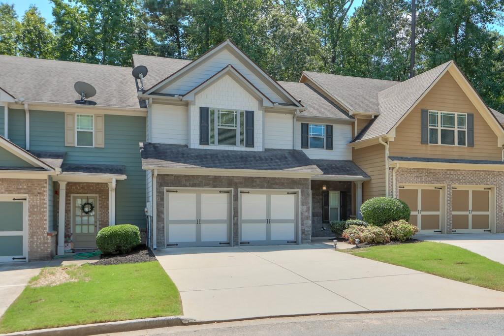 Move-in ready townhome in Brownstone Square - a GATED community a couple of miles from historic downtown Marietta. The entrance foyer leads to a powder room on the right and there are beautiful, new LVP floors flowing from the foyer into the cozy, fireside family room. This OPEN CONCEPT main level has a gourmet kitchen with tons of cabinets and counter space which overlooks the family room and separate dining room. Access your back patio from the dining room which overlooks a peaceful, wooded area. Upstairs features the oversized master bedroom with vaulted ceilings, hardwood floors, and an UPDATED bathroom offering a soaking tub, separate shower, and upgraded ceramic tile floors. There's also an enormous, walk-in closet with custom shelves and drawers. Two generously-sized bedrooms are also upstairs that share a full bathroom. And the laundry room is conveniently located on the upper level. Some additional upgrades include fresh/neutral interior paint & updated lighting, and there's NO CARPET! This is an active community with a pool and the HOA takes care of the lawn & the home exterior. You can't beat the location - 2 miles from the Marietta Square and only 8 miles from the Braves Stadium - and conveniently located near the interstate for an easy commute. Honestly a rare find!