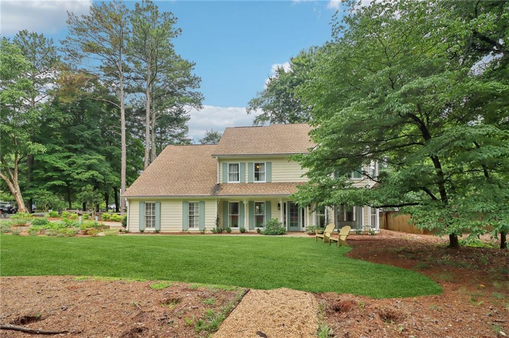 Exceptionally maintained and full of character, this stunning craftsman-style home blends timeless original details with thoughtful modern updates, and NEWER HVAC, all while being situated on a beautifully landscaped corner lot in prime East Cobb, zoned for top rated schools. A welcoming covered rocking chair front porch and manicured lawn set the tone for the quality and care found throughout. Inside, gleaming hardwood floors, detailed trim work, stylish fixtures with medallions, and a classic brick gas fireplace bring warmth and sophistication. The formal dining room, currently serving as a home office features elegant wainscoting and flows into an eat-in peninsula kitchen with granite countertops, stainless steel appliances including a wall oven and gas cooktop, vent hood, and a complementary tile backsplash. An additional casual dining area, family room, and adjoining formal living room create an ideal main level layout for everyday living and entertaining. Upstairs, the spacious primary suite boasts a double vanity, frame-less glass shower, soaking tub, and private water closet. Three generously sized secondary bedrooms, a full bathroom with skylight, and a dedicated laundry room complete the second level. The finished third level features two versatile bonus rooms, perfect as additional bedrooms, playroom, home office, media or reading rooms. Endless possibilities! Step outside to a serene backyard featuring a charming gravel patio lined with brick pavers, a cozy pergola, and even an adorable tree house!! No HOA and just minutes from popular shopping, dining, grocery, healthcare, parks, and year-round entertainment. This is a rare East Cobb gem that truly offers it all.