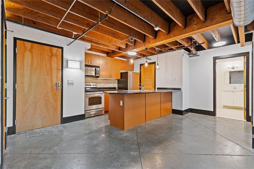 Amazing two-story loft with 2 bedrooms in the heart of Marietta! Perfect mix of urban, contemporary, and modern design in this open floor plan w/exposed brick walls and concrete floors. The renovated kitchen boasts gorgeous granite countertops, brick backsplash, huge island w/breakfast bar and stainless-steel appliances. Large walk-in pantry with custom shelving. Freshly painted interior and polished concrete floors. Gated and covered parking plus storage unit. Enjoy the roof top deck with views of the city. Walk to Marietta Square! Marietta Square has so much to offer including Marietta Square Market Food Hall, Glover Park Brewery, Taqueria Tsunami, Douceur de France French Bakery & Café, Kiosk, Two Birds Taphouse, and so much more. Also, enjoy the Friday Art Walks in the Square, Glover Park Concert Series, Farmers Market every weekend, and tons of art & music events throughout the year! Fitness center is located on Level M. Roof top deck is on 5th floor. There is a staircase on the side of the building that leads to the units too. This unit has one designated parking space and one designated storage. The unit has 2 balconies.