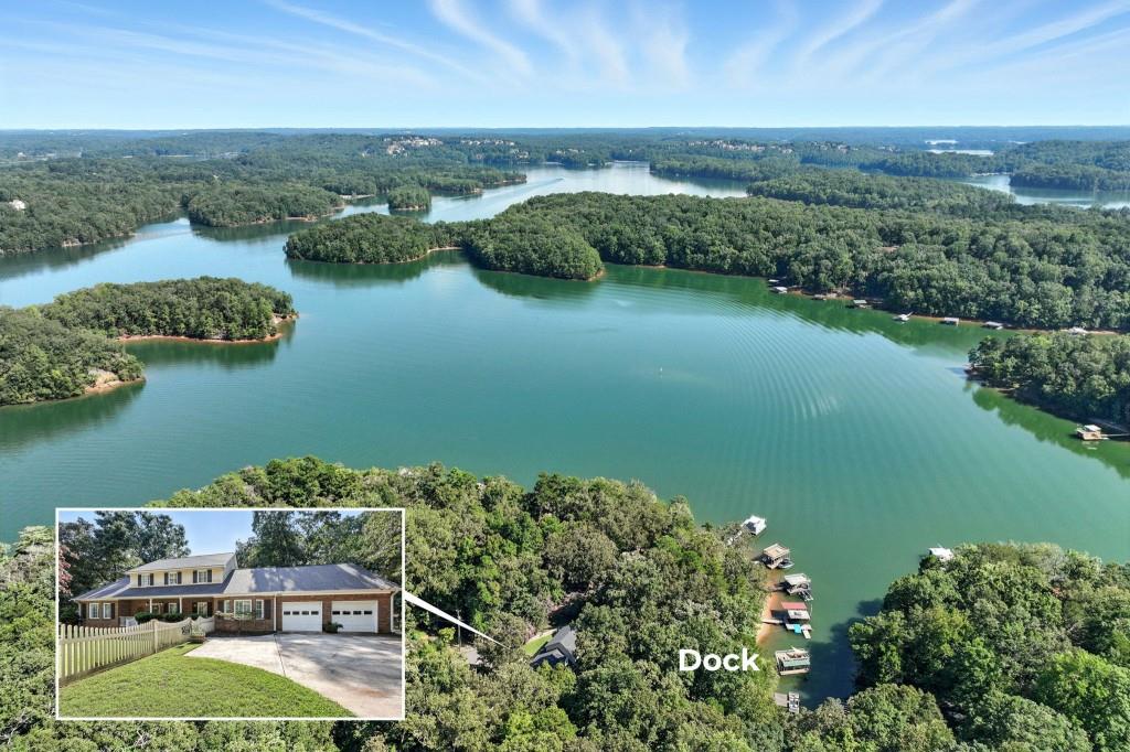 This rare Lake Lanier find offers 4 bedrooms, 4 full baths and 2 oversized bonus rooms making it the perfect retreat for entertaining, relaxing, and enjoying the lake lifestyle. To top it off, the home is being sold completely furnished! From the level driveway and inviting front porch, you'll step into a thoughtfully designed home with a graceful flow from the foyer and staircase into the family room, currently enjoyed as a recreation space, and then on to the great room with a cozy fireplace. A wall of windows frames sparkling lake views and draws you into the large, open kitchen with stainless steel appliances, granite countertops, and a bright breakfast area, while the separate dining room provides plenty of space for gathering with family and friends. The main level also includes a spacious suite with an oversized full, along with a convenient half bath and another full bath just off the kitchen for easy access after a day on the water. A large laundry room with sinks makes it simple to handle wet towels and lake gear. Upstairs, five generously sized bedrooms and a full bath provide comfortable accommodations for all your guests. The outdoor living is just as inviting, with an expansive screened-in porch overlooking the water, a side deck with connections for a hot tub in place and a separate grilling deck with ample space for outdoor seating. From there, it's just an easy walk to your private single slip dock with party deck and electricity, where you'll enjoy year-round deep water and wide, open views of the lake. Practical touches add even more appeal, including plenty parking space, two fenced-in yard areas, and a storage shed for all of your lake toys. Nestled on a quiet street, the property is just minutes from War Hill Park boat ramp, Athens Boat Club for gas and fireworks, quick access to Ga 400, Dawsonville shopping, restaurants, hiking, Dahlonega, and North Georgia's favorite wineries. With its blend of comfort, convenience, and its proven success as a short-term rental, this is a rare opportunity on Lake Lanier that you won't want to miss!
